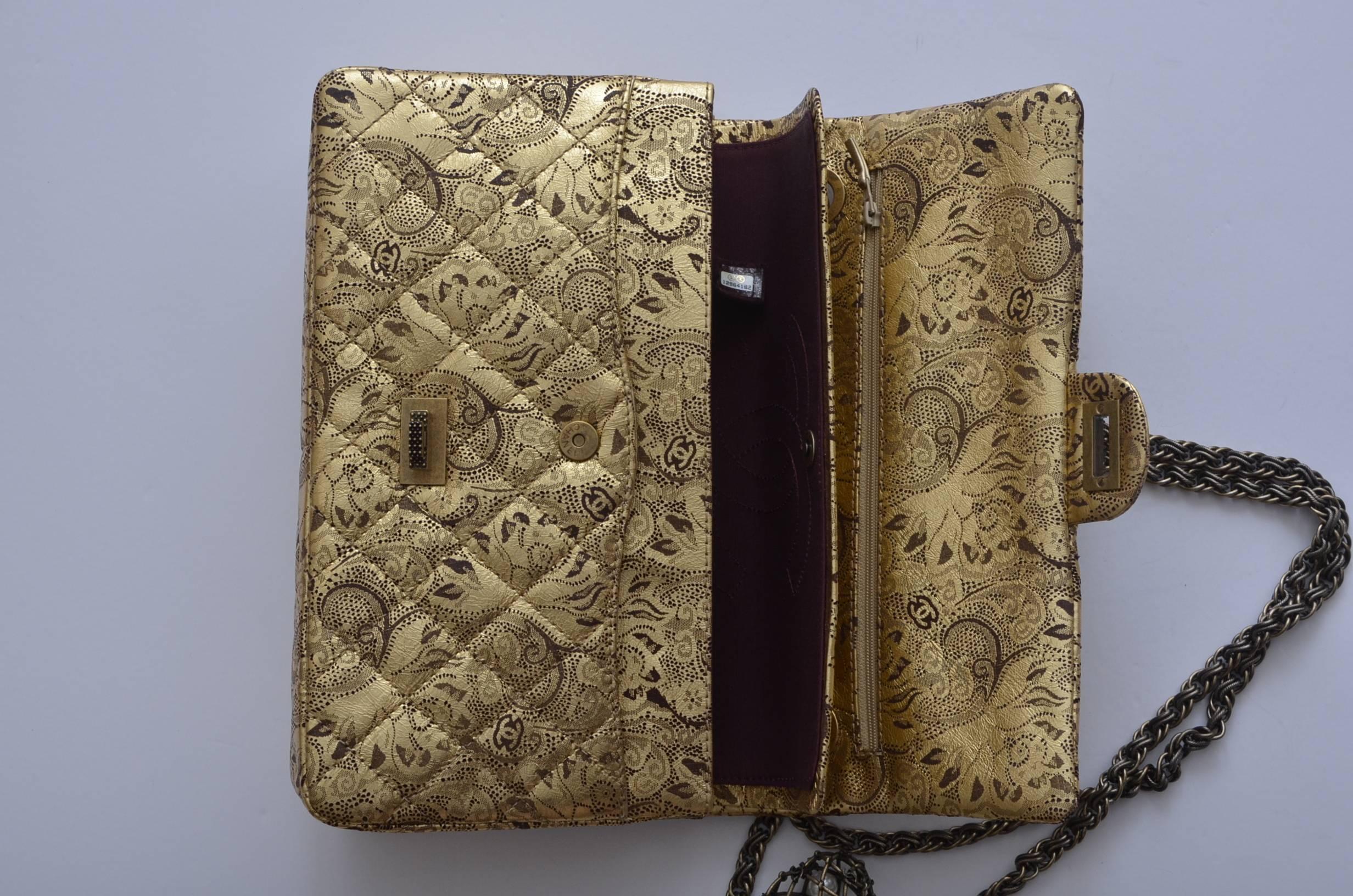 Chanel limited edition faberge egg  double flap handbag .
From Paris-Moscow collection.
Brown paisley on gold quilted leather with lot's of CC Chanel print.
Distressed gold hardware with double chain handle .
Faberge egg large charm with cc's