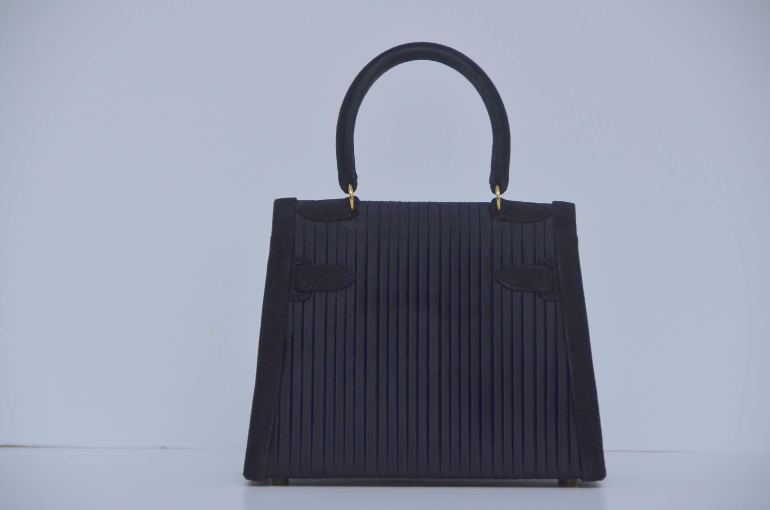 Extremely rare Hermes Mini Kelly bag 20 cm black pleated Satin & Veau Doblis suede leather with gold hardware.
Definitely collector's piece.....
Excellent mint vintage condition.Satin and suede in excellent condition,couple marks inside.Lined in