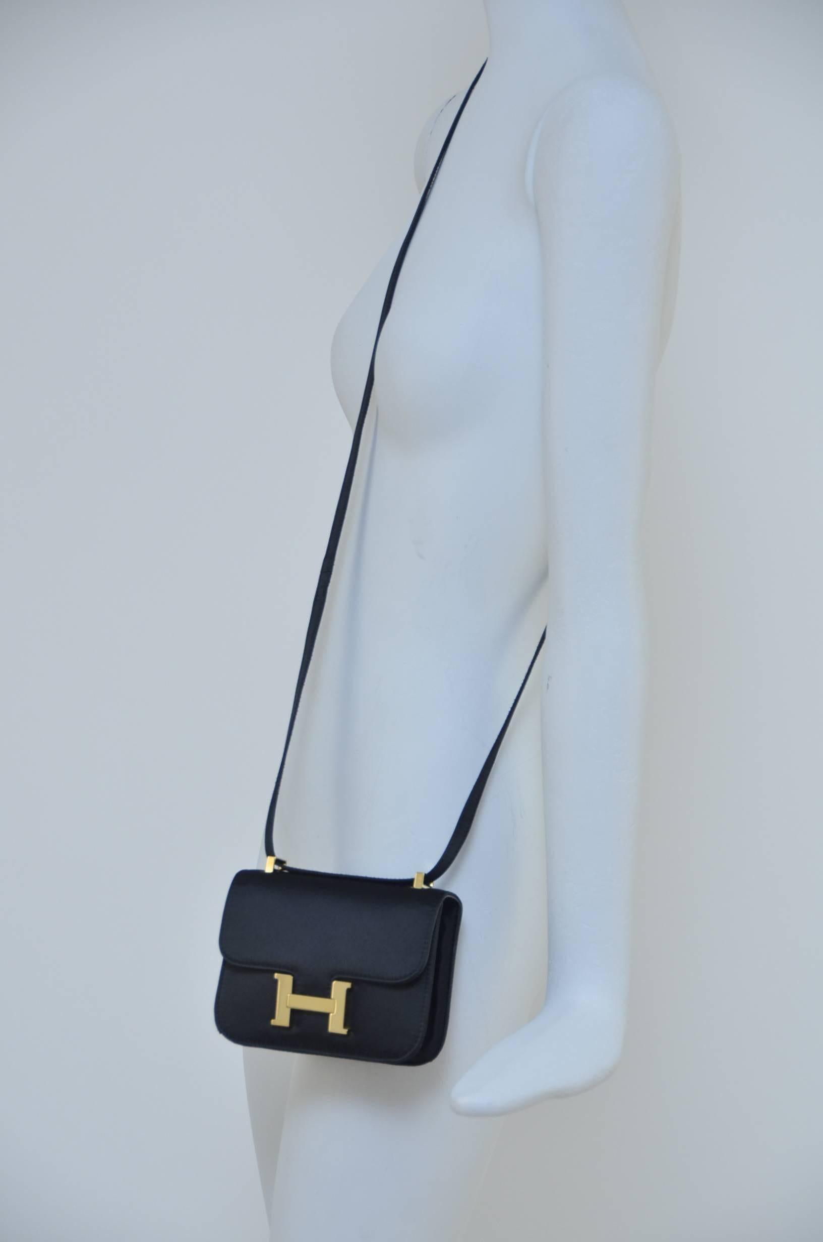 Hermès Satin Micro Mini Constance bag .
Super rare and impossible to find .
This is definitely a statement bag that could be used day or night  with unique strap that could be  used cross body or doubled for evening night out.
Gold tone