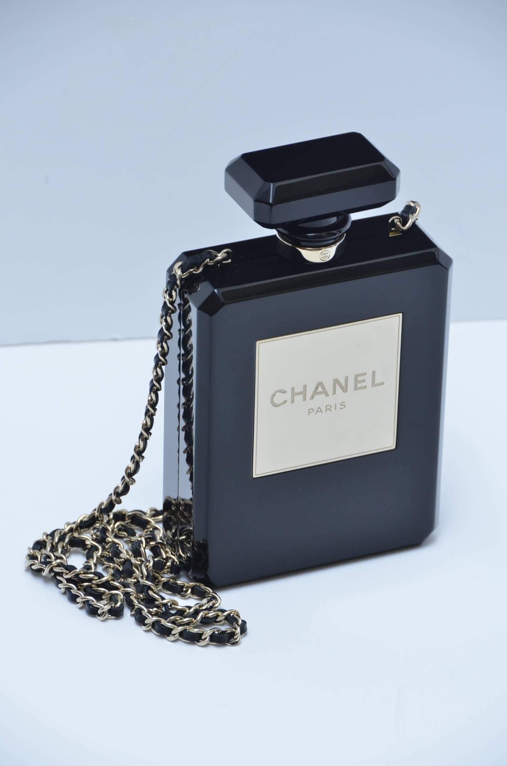 Limited Edition  runway  black plexiglass CHANEL No. 5 Perfume bottle  handbag /clutch.
Excellent mint 9 out of 10 condition.Few very minor hard to see hairline scratches outside and inside.Lined in lambskin leather inside.
Hologram inside and