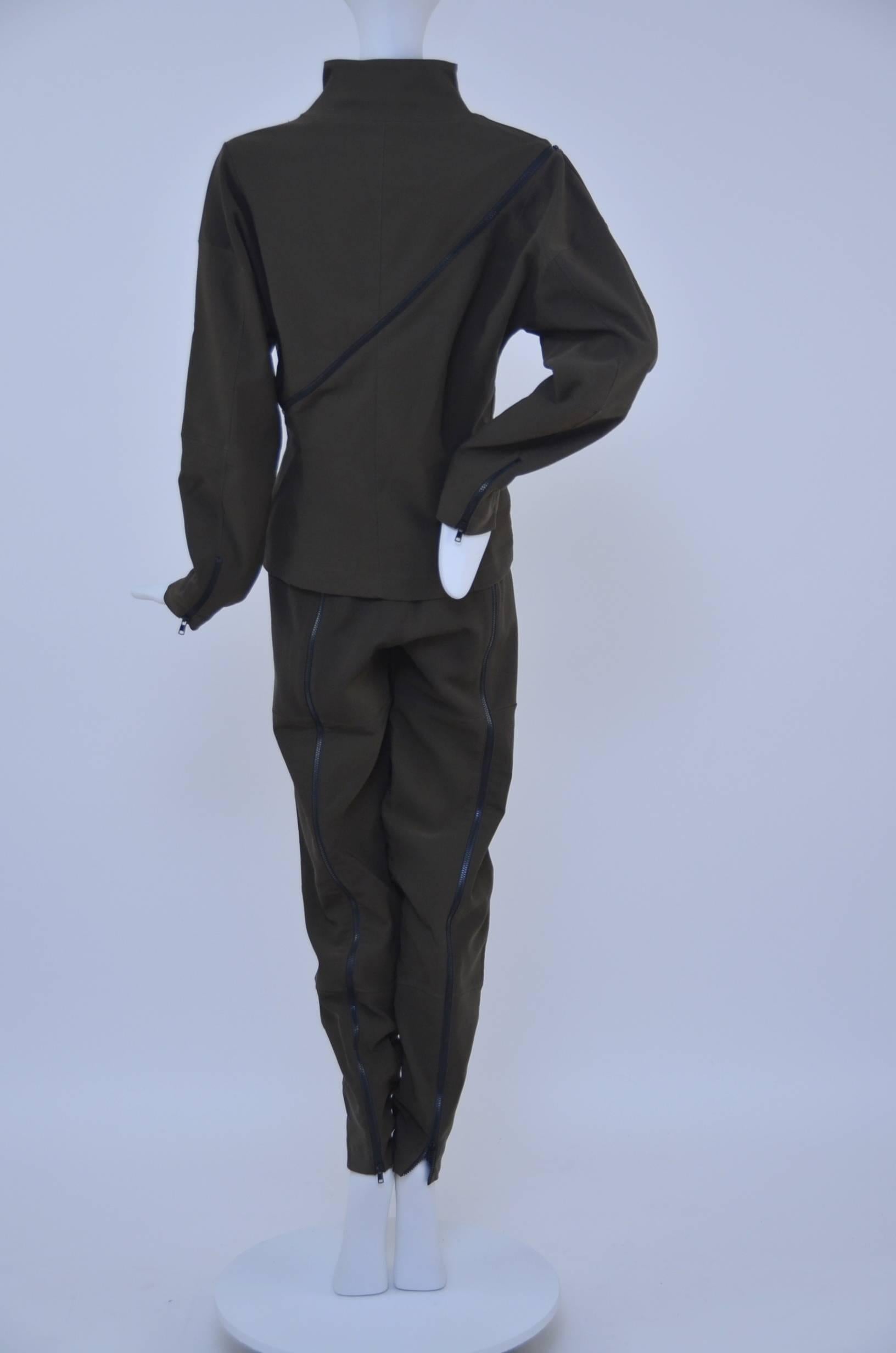 Issey  Miyake runway  zipper  suit.Very unique interesting design.
Jacket has multiple zippers, on the collar, sleeve and one large zipper that goes form the front to the back.Pants have 2 little zippers in the front and large zippers on the back