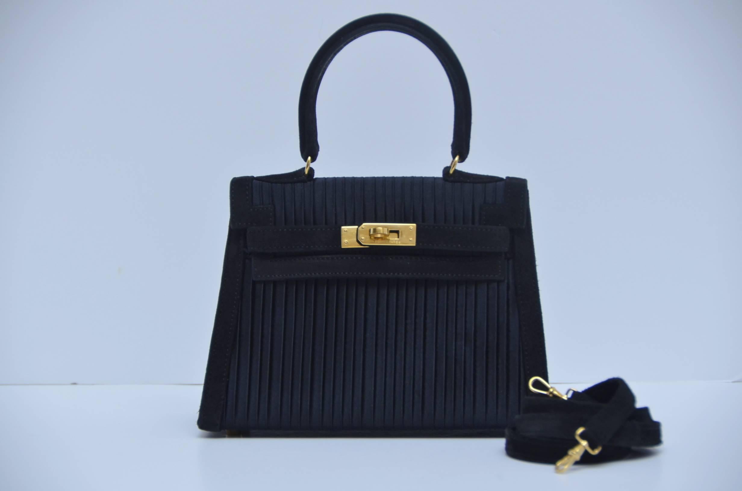 Extremely rare Hermes Mini Kelly bag 20 cm black pleated Satin & Veau Doblis suede leather with gold hardware.
Definitely collector's piece.....
Excellent mint vintage condition.Satin and suede in excellent condition,couple tiny marks inside.Lined