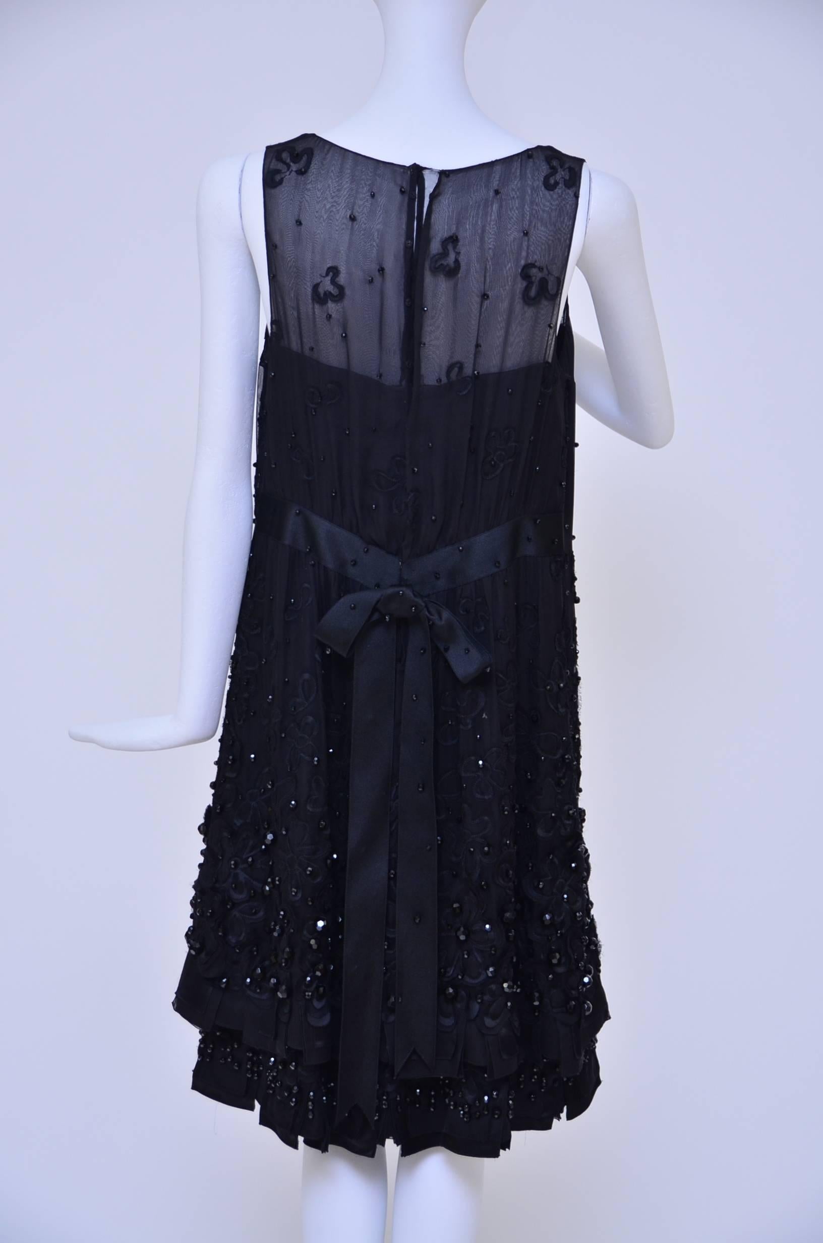 Beautiful Chanel Haute Couture black silk embellished/beaded dress.
Of course ,it was made for a very special Chanel client and it is absolutely beautiful in person.
Heavily beaded/embellished  with few different size of beads and  embroidered
