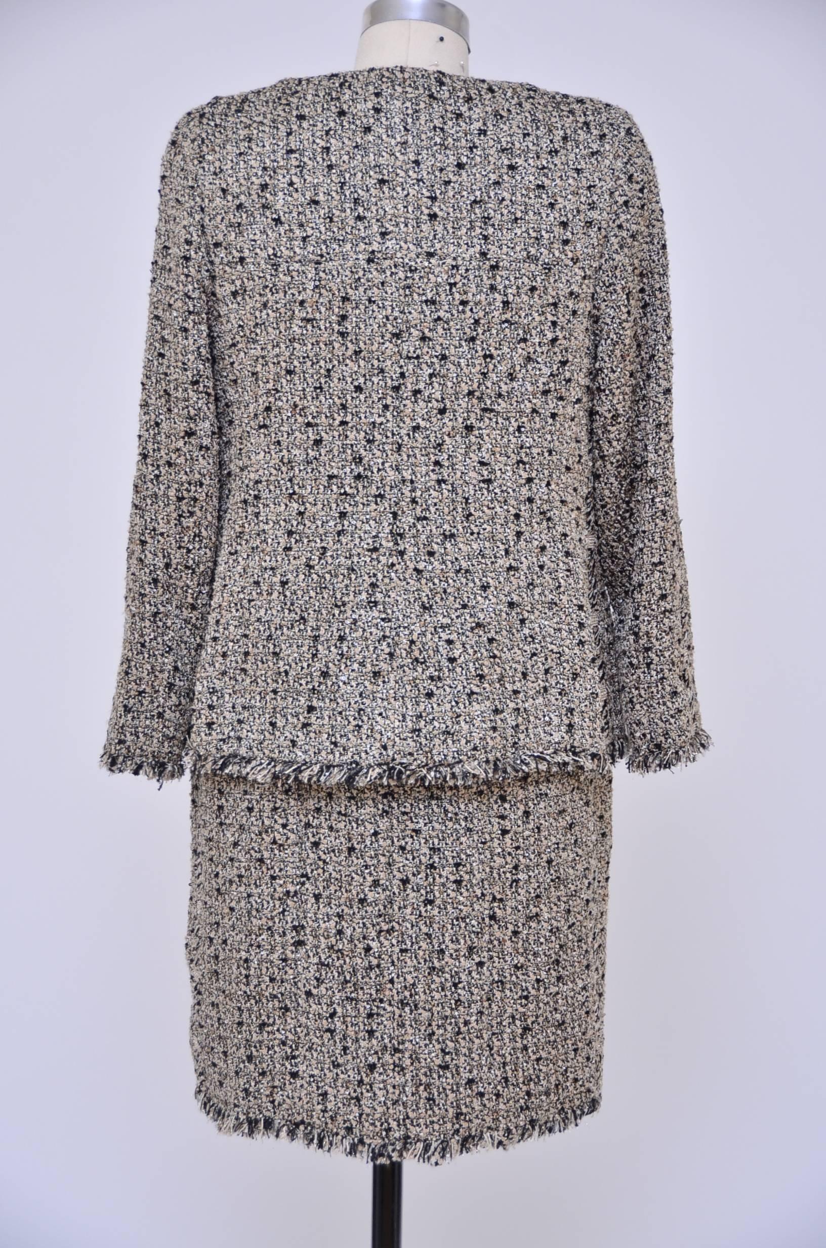 Beautiful Chanel Haute Couture tweed dress with matching jacket.
Crystals embellished gold tone buttons on the jacket and on the side of the dress.Also same matching square pieces used around the neck of the dress and on the side.So many amazing 