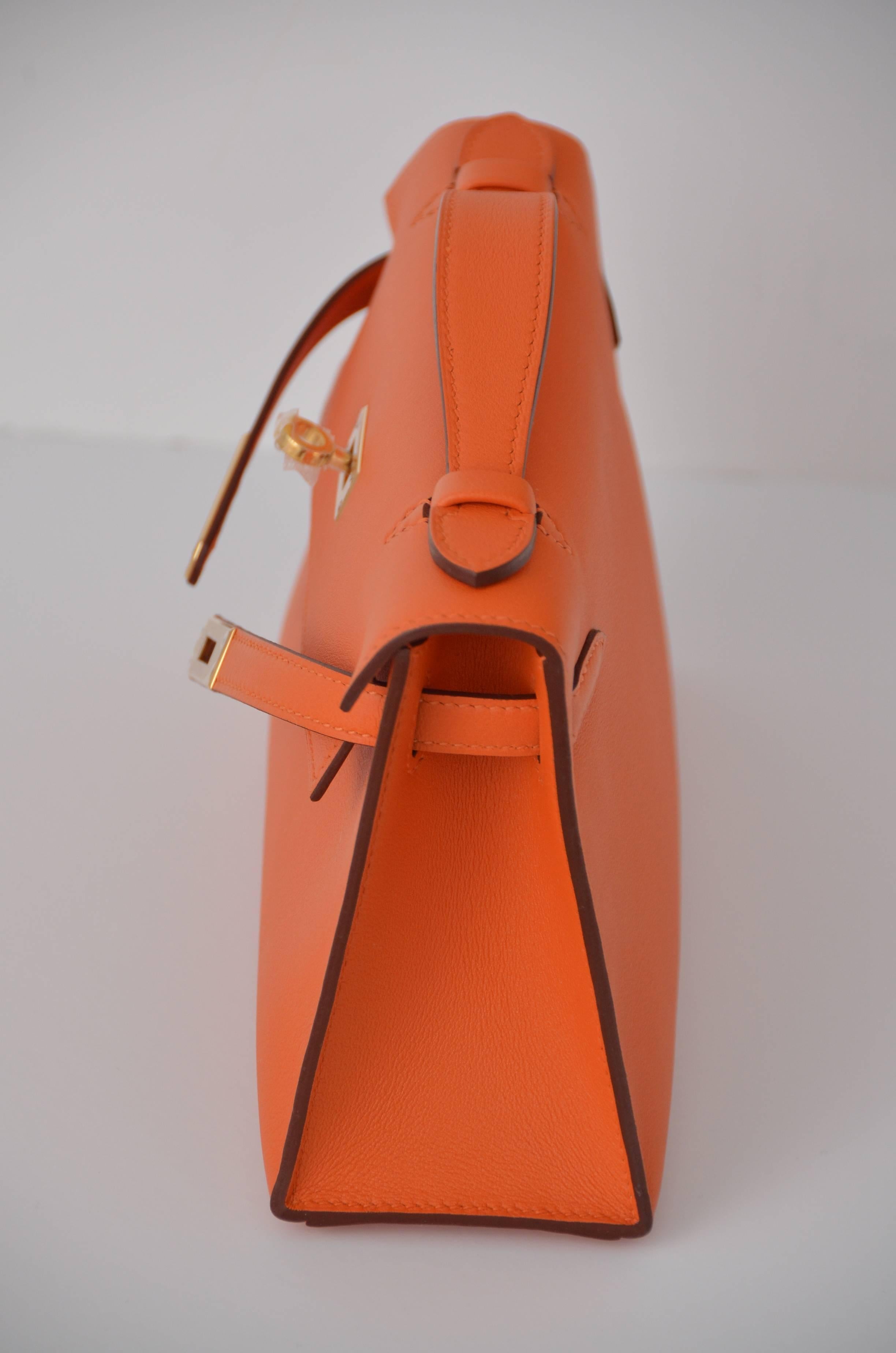 Hermes Kelly mini pochette Veau Swift orange color. 
Brand new ,never used. Gold hardware. Comes with box,dust-bag. 

Due to camera flash light color in person might be slightly different. 

Made in France.  

FINAL SALE.
