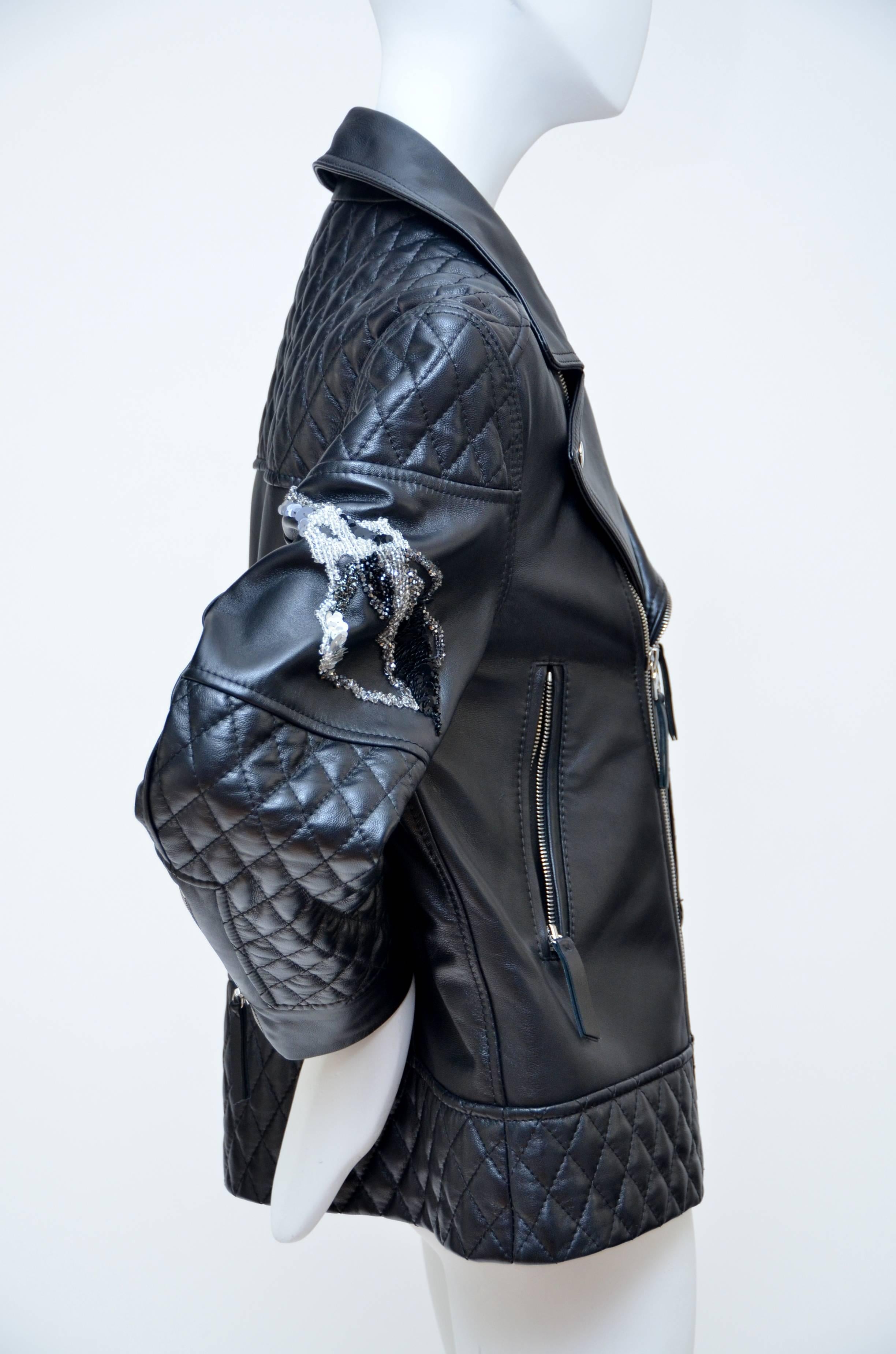 Black Giles leather jacket with quilted detail throughout,multiple pockets, black and grey sequin embellishments at sleeves, front zip pockets and zip closure at center front.
Condition: Excellent,looks unworn.
Measurements: Bust 39”, Waist 38”,