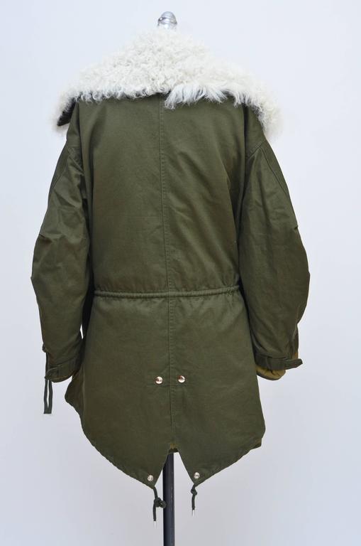 One of the most coveted styles of the season, this luxurious parka is a modern reinterpretation of archival Balenciaga couture. 
Lined in sumptuous shearling, it's cut from army-green cotton-twill in an oversized cocoon shape, with the option of