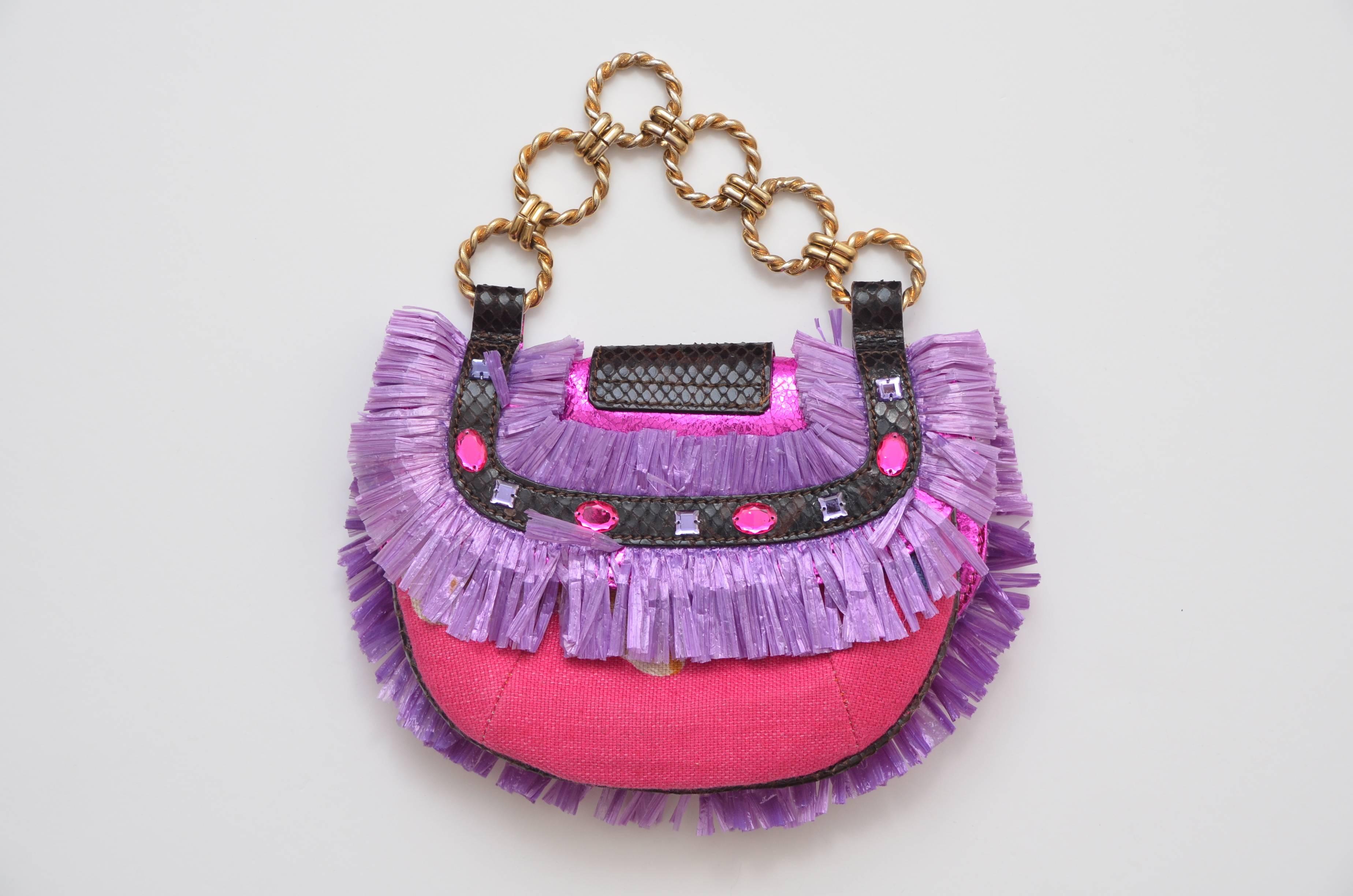 Super cute mini D&G Dolce Gabbana straw handbag.
Mixed colors of fabric printed , metallic fuchsia straw  ,purple,dark brown and embellishments.
Excellent mint condition.
Made in Italy.
Snap closure.
So many details on this mini purse.
Approximate