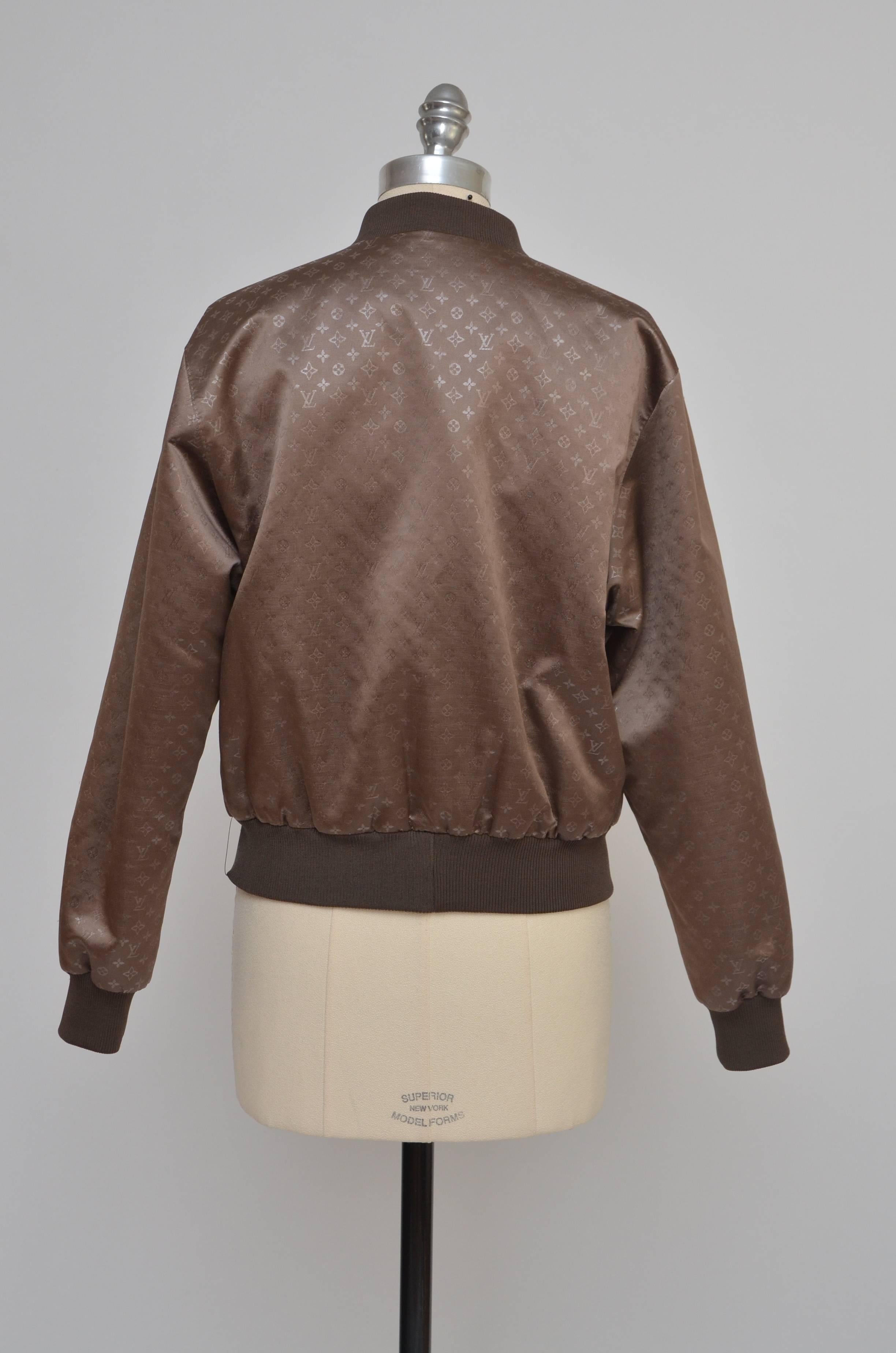 Louis Vuitton silk monogram jacket  with dual welt pockets at sides, rib knit trim and button clasp  snap closures at center front.
Size 38 FR.
New condition without tags.
Approximate measure:Bust: 40