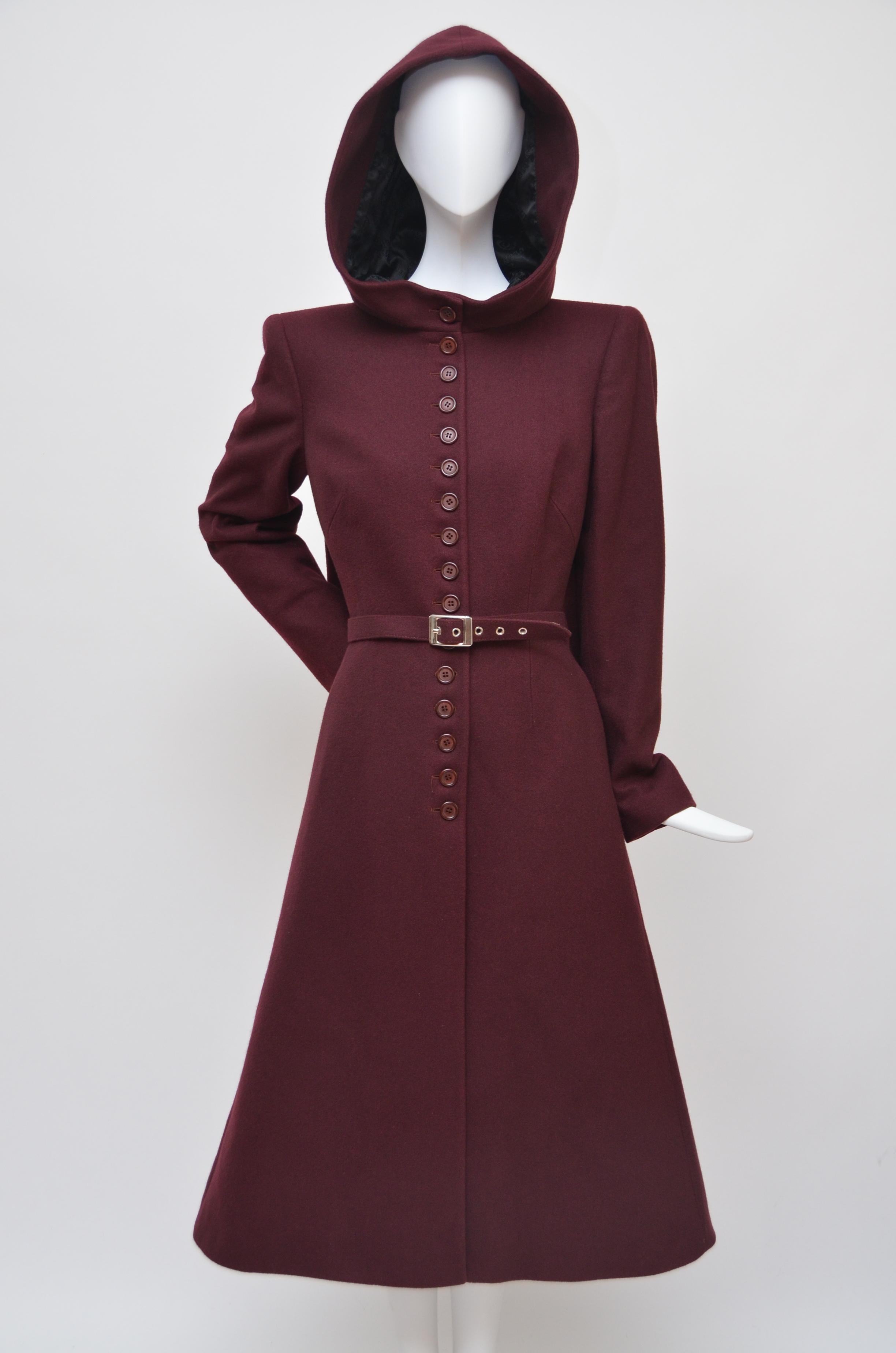 Alexander McQueen burgundy coat with hood.
Exact coat as seen at  this runway  1998 collection.
Coat has belt opening on the side and comes with original belt.
Lined in black Alexander McQueen signature print fabric.
Button closure . Excellent mint