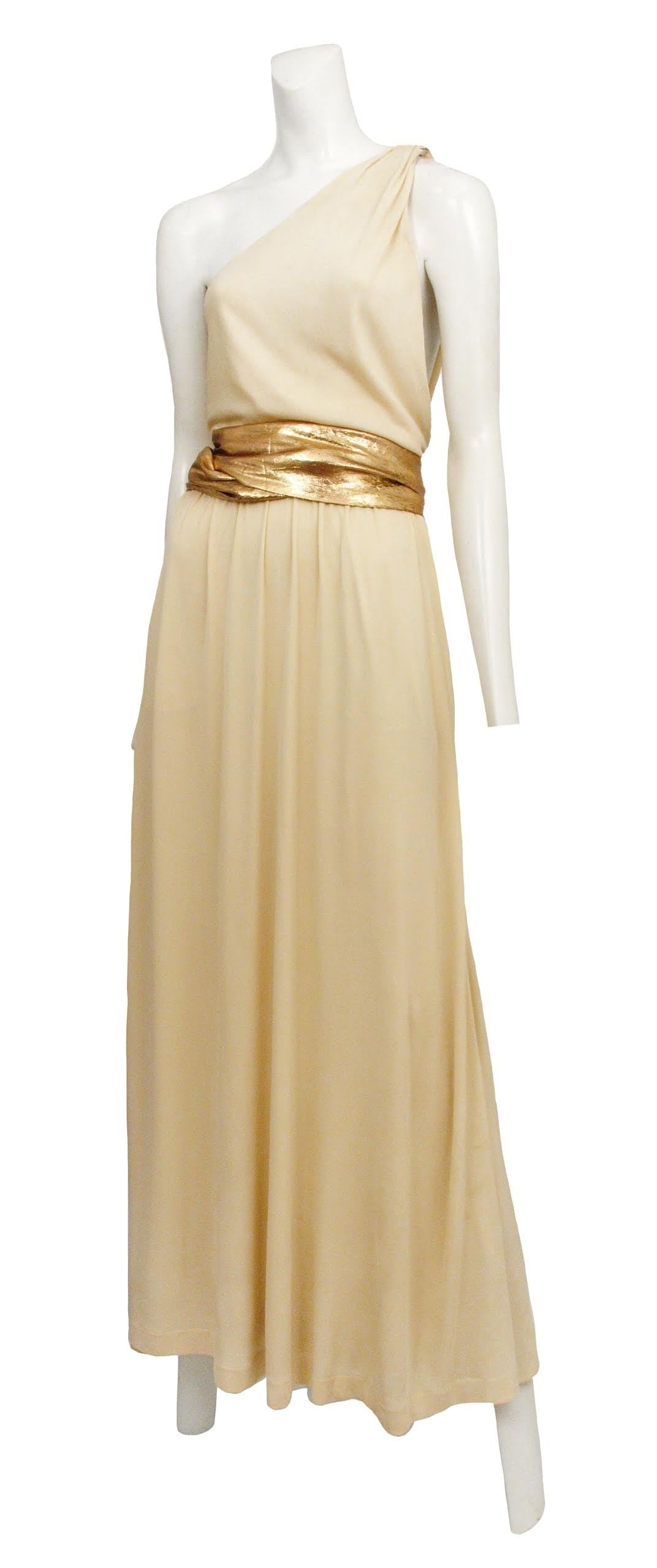 Vintage Saint Laurent Rive Gauche 1970's cream jersey asymmetrical gown with gold lame belt.