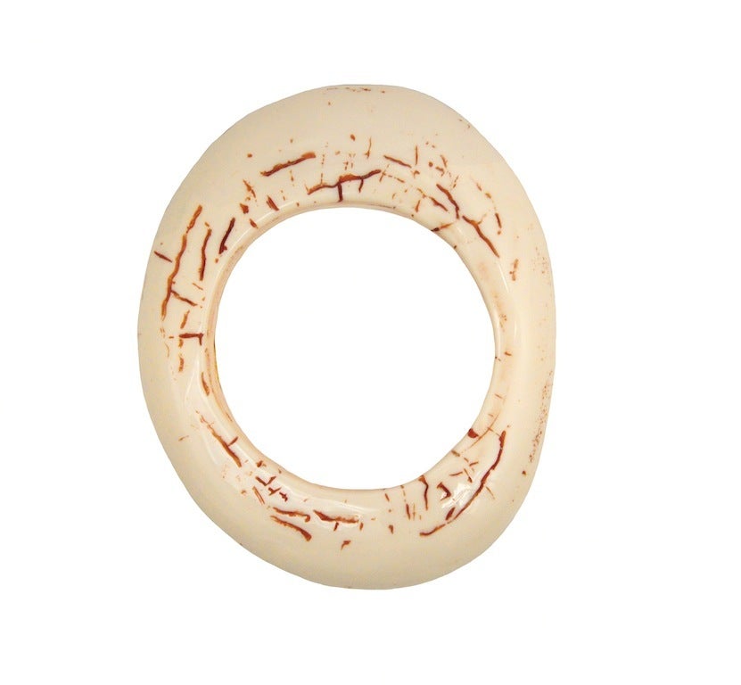 Vintage Chanel faux ivory bangle with iconic interlocking CC etched in top.