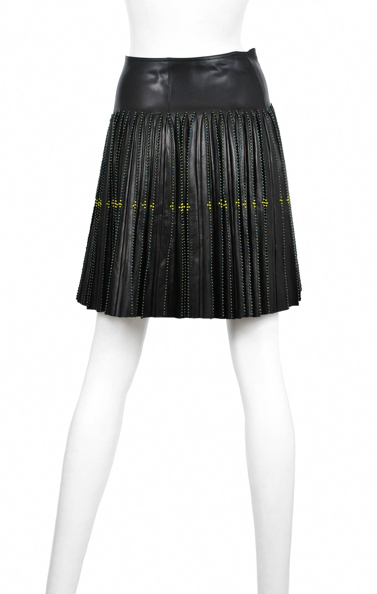 Vintage Azzedine Alaia leather skirt with full pleated wrap detail, beaded trim finish, and buckle belt closure. Circa 2001.