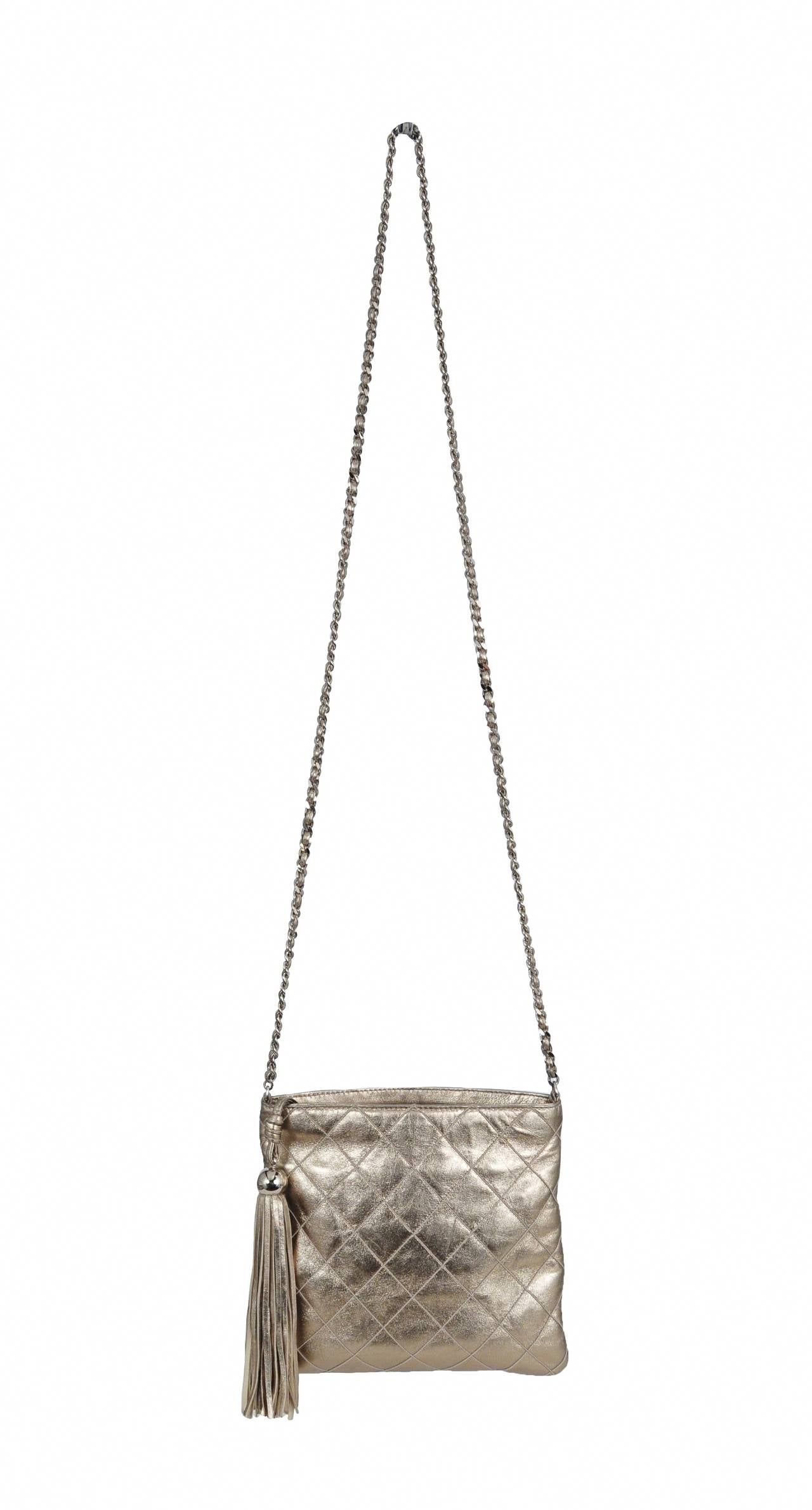 Chanel light gold square cross body bag with extra long tassel and silver braided chain. 

Chain strap is 24