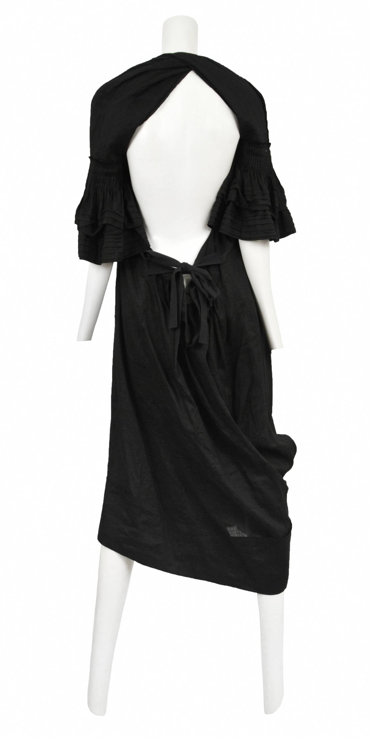 Vintage Tao for Comme des Garcons black linen blend cropped jumpsuit with front panel bow detail & attached waist tie closure. Circa 2007.