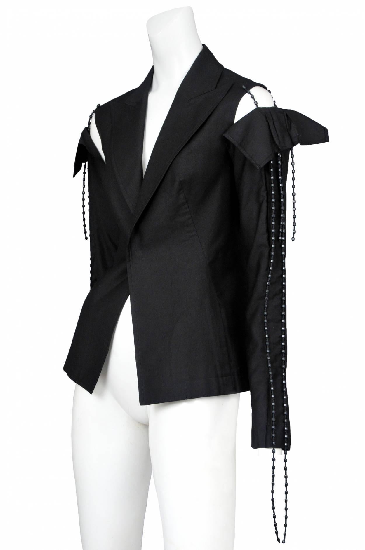 Vintage Yohji Yamamoto black blazer featuring a pointed collar, detached shoulder seams and beaded trim that hangs from the shoulders and sleeves. Runway piece from the Spring/Summer 2014 Collection.