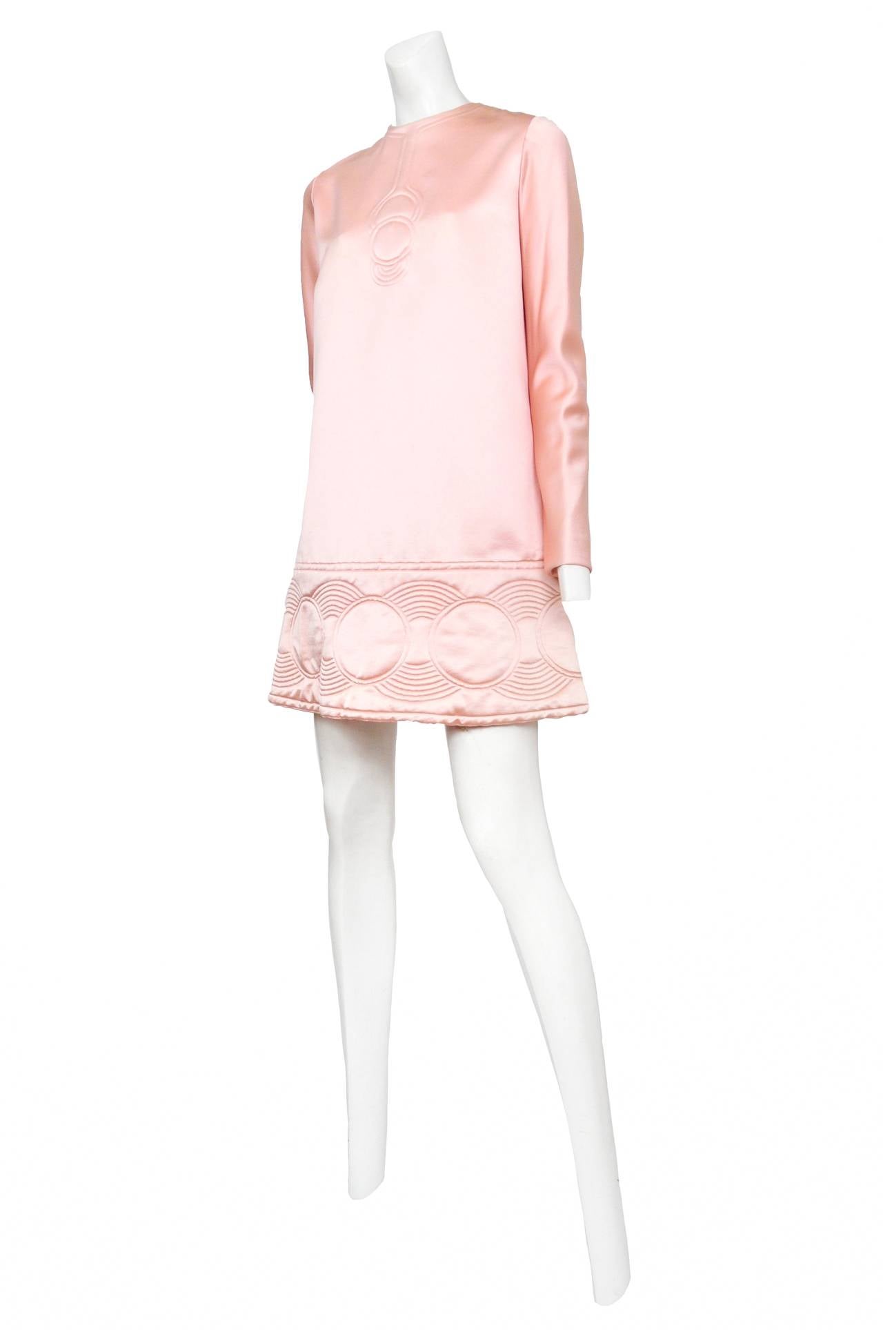 Vintage Pierre Cardin soft pink duchess satin long sleeve shift dress featuring iconic Cardin circular stitch details at neckline and surrounding hem.