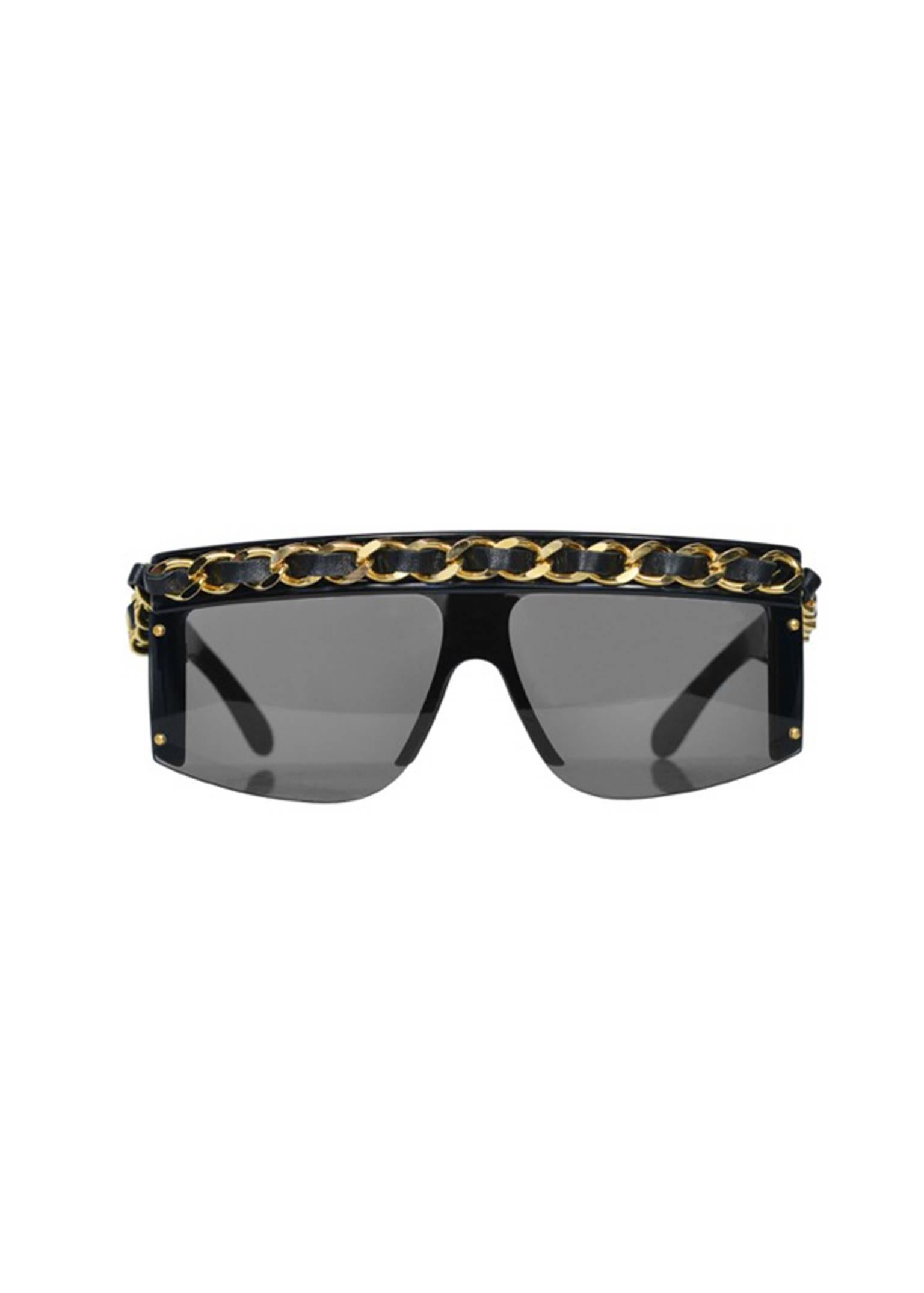 Iconic vintage Chanel black oversized sunglasses with signature chain across brow. Collection 1992. Glasses come with black leather quilted hard case and Chanel box. Glasses look to be unworn. 

Lens. W 2.8 " x H 2.2 " 
Frame. Width. 5.5