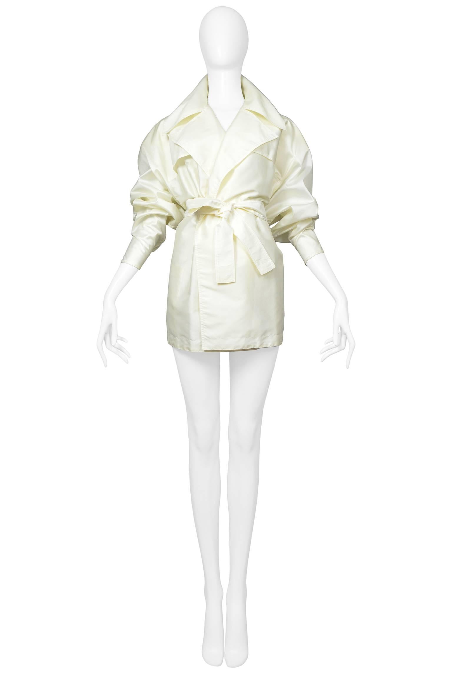 Vintage Azzedine Alaia buttonless pale ivory mini trench coat with oversized collar, soft shoulders, and tie belt. Easy fit for size small or 2-6 US. 