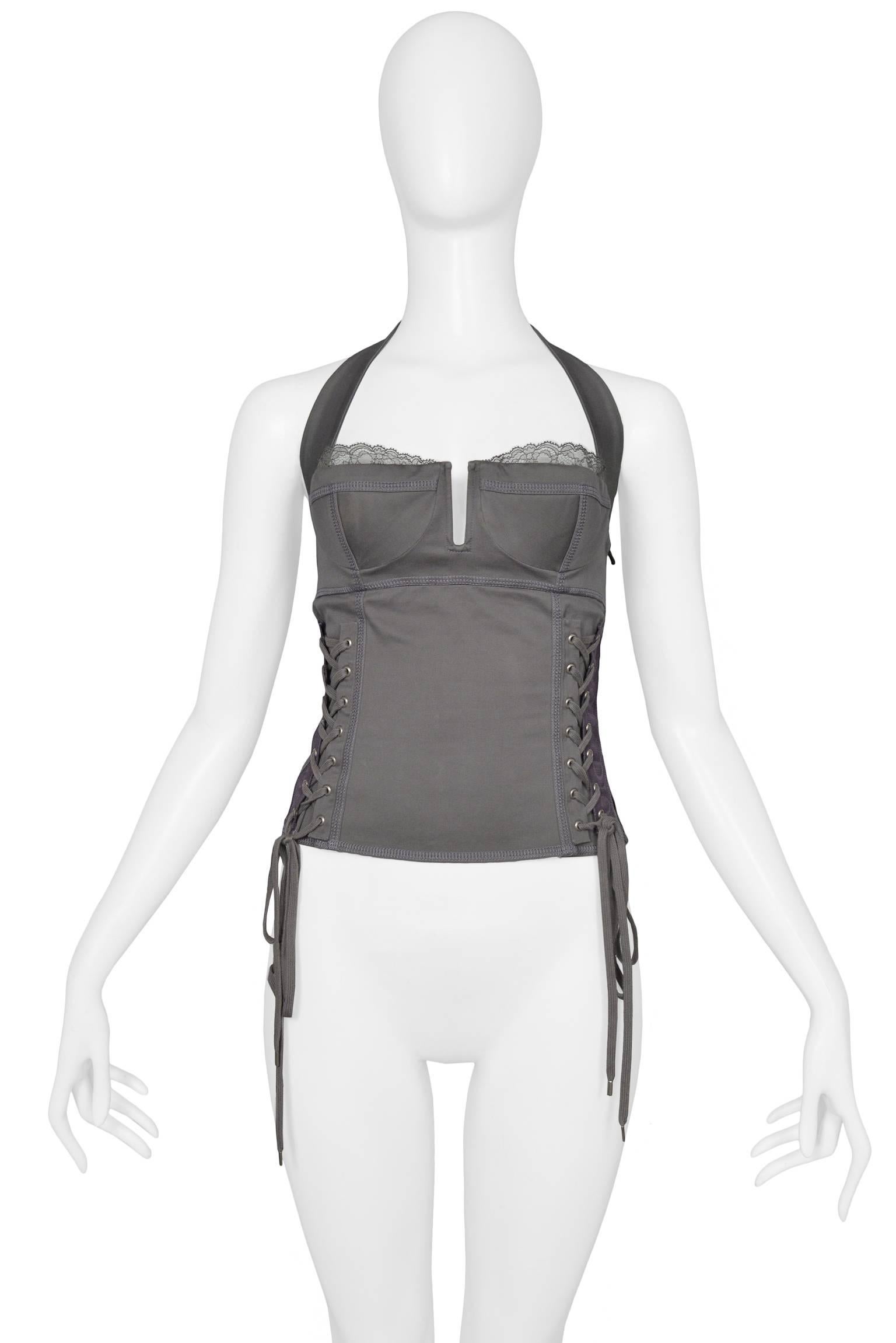 Dior by John Galliano grey cotton bustier with corset laces at side and "Dior " logo tape (See pics). Halter neck with star charm, open back, and lace over bra cups. Circa, 2004. 

Marked size 38 and fits like a today's small. 