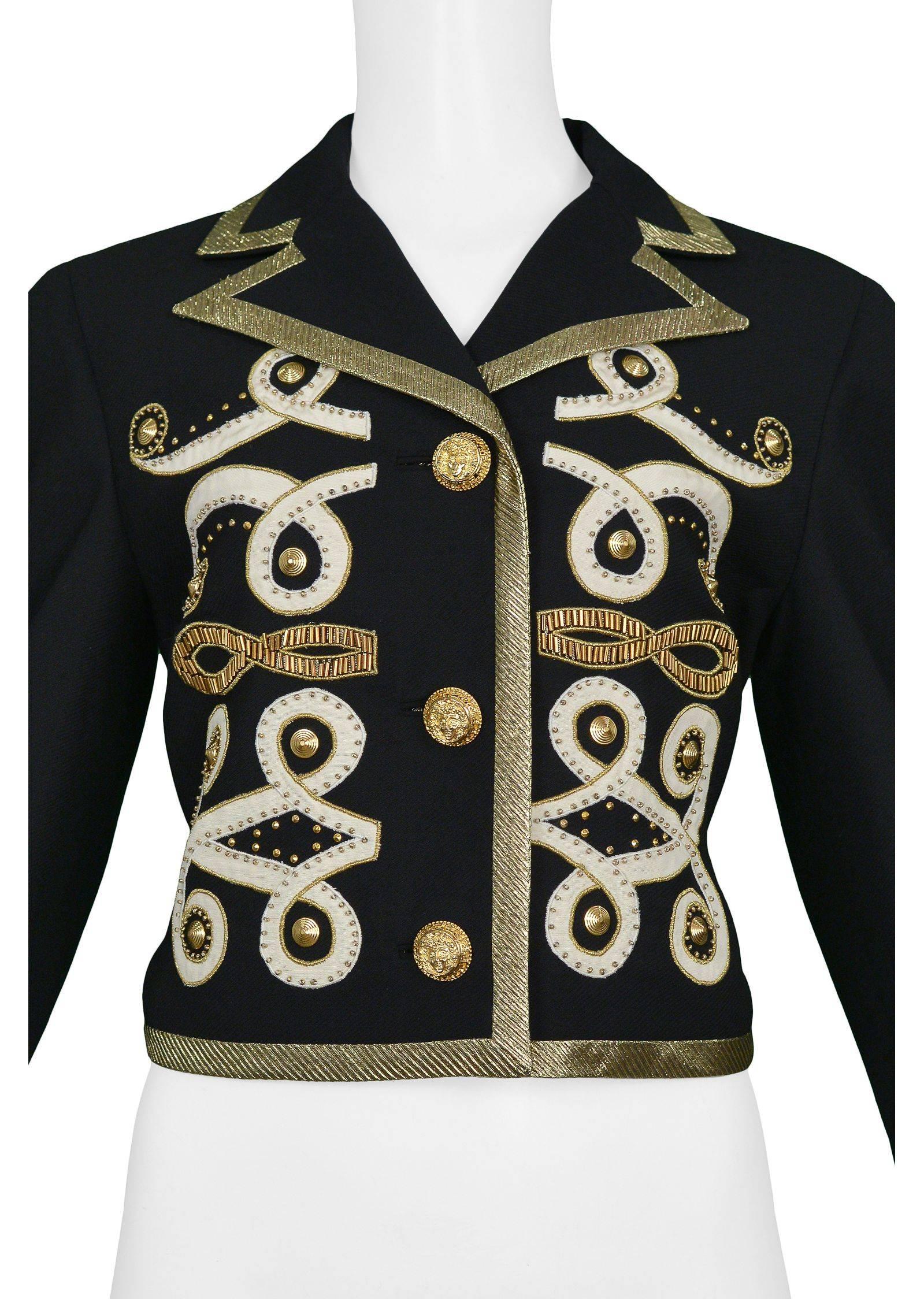 Vintage Gianni Versace black wool button front jacket. The jacket features gold fabric trim and Versace's iconic Baroque applique detailing, gold studs, and gold Medusa head buttons.