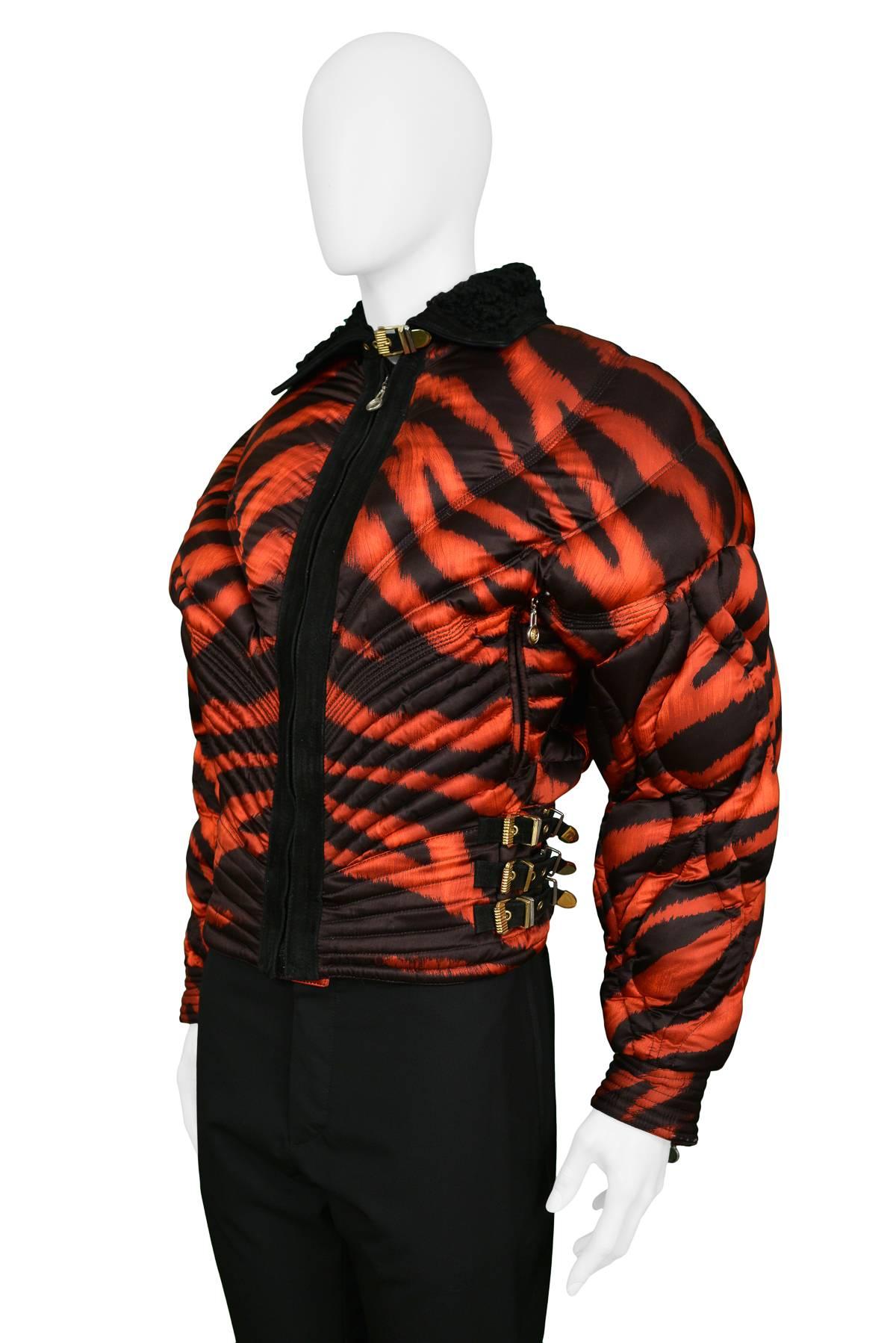 Gianni Versace rare apres quilted ski jacket with red and black tiger print. Corset style waist has leather and gold bondage buckles. The zipper pulls through out are adorned with the Medusa icons. Jacket is trimmed in black suede with Mongolian fur