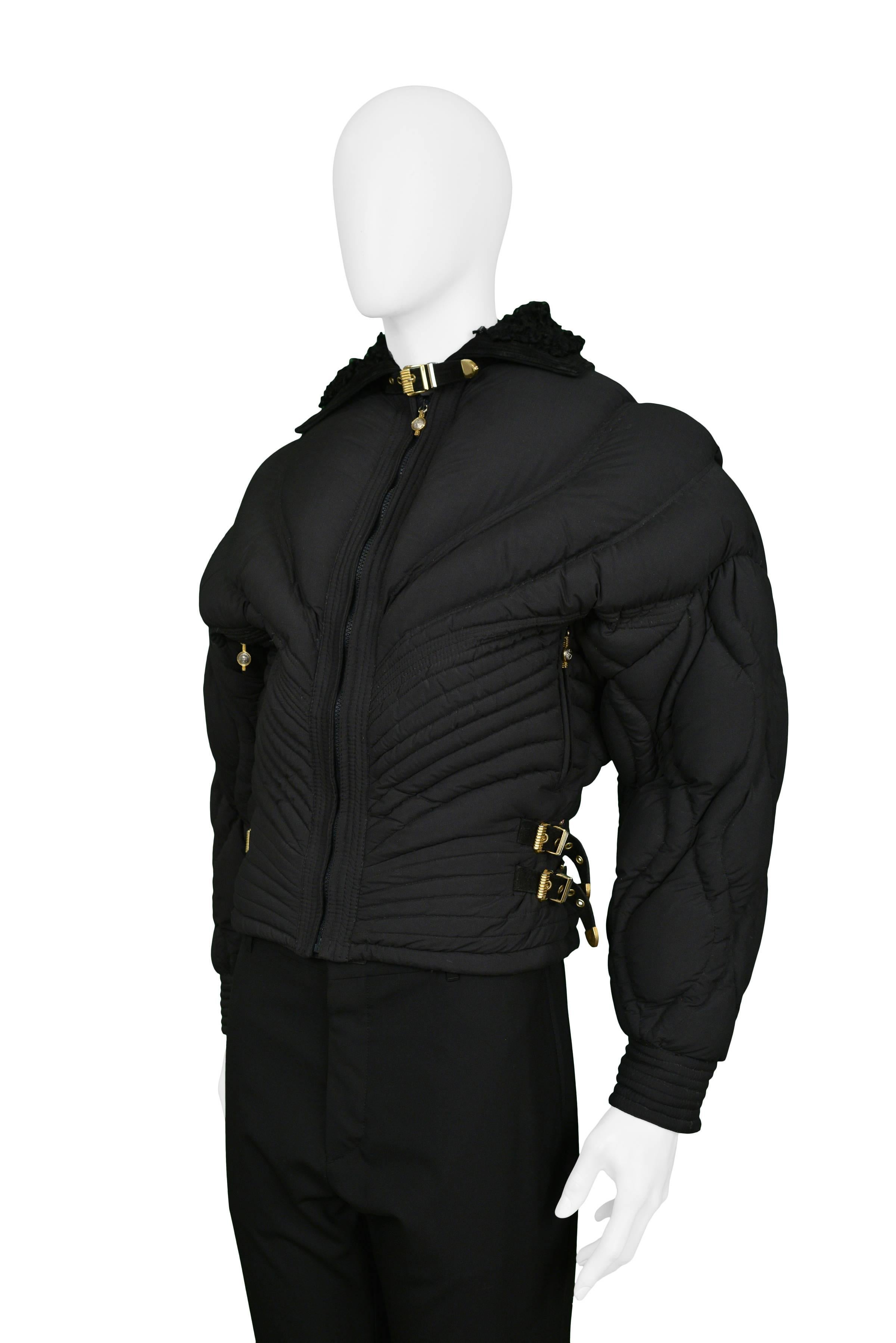 Vintage Gianni Versace rare apres quilted ski jacket in black brushed rayon. Corset style waist has leather and gold bondage buckles. The zipper pulls through out are adorned with the Medusa icon. Jacket is trimmed in black suede with Mongolian fur