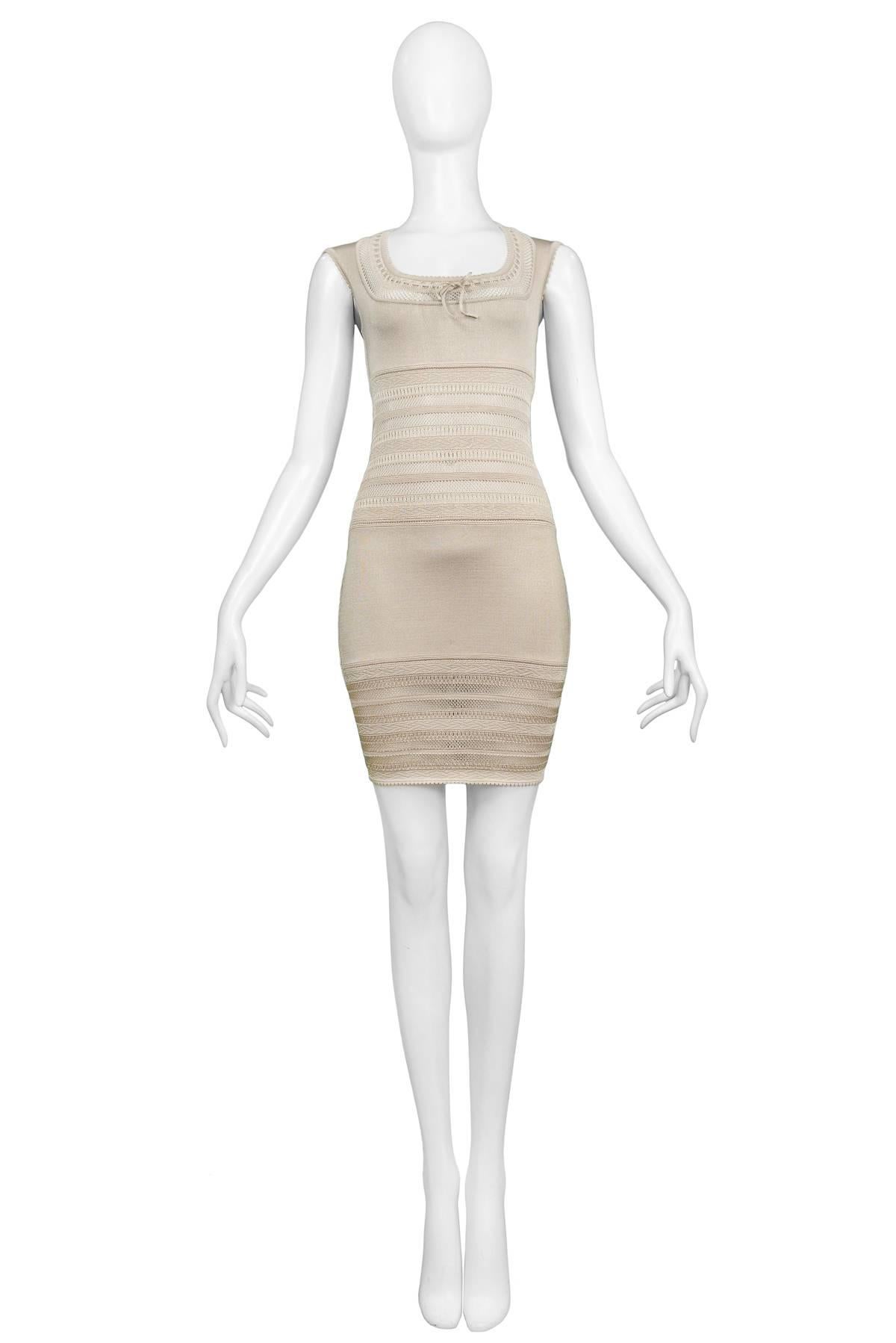 Vintage Azzedine Alaia beige fitted dress with knit lace bodice. Features square neckline, bow at front and zipper at back. The dress fits a today's size 4. Please contact us for measurements. 

Excellent Vintage Condition.

Measurements:
Bust 30
