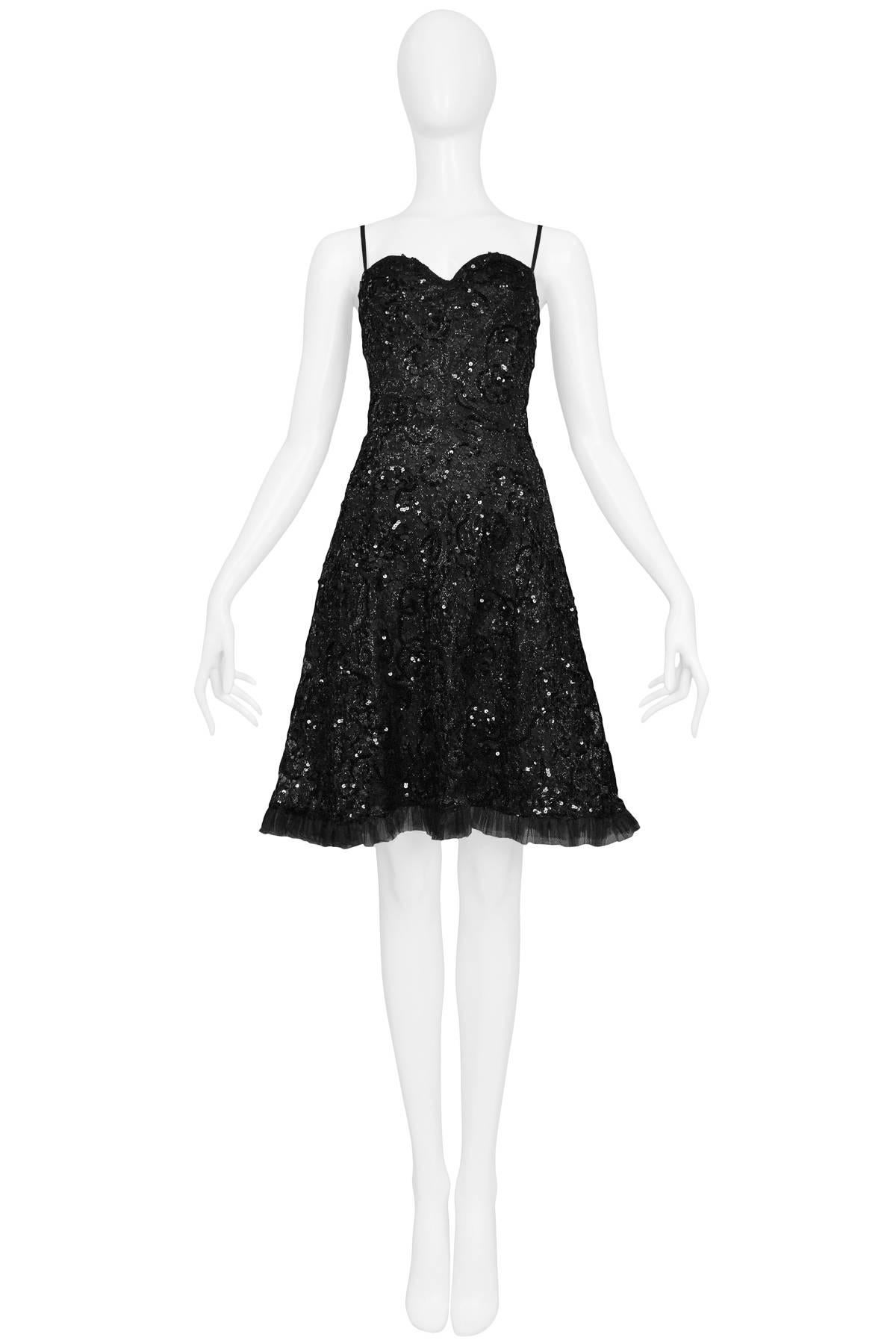 Original black lace and sequin Yves Saint Laurent cocktail dress with black organza ruffle hem and sweetheart neckline. Circa late 1970's. 