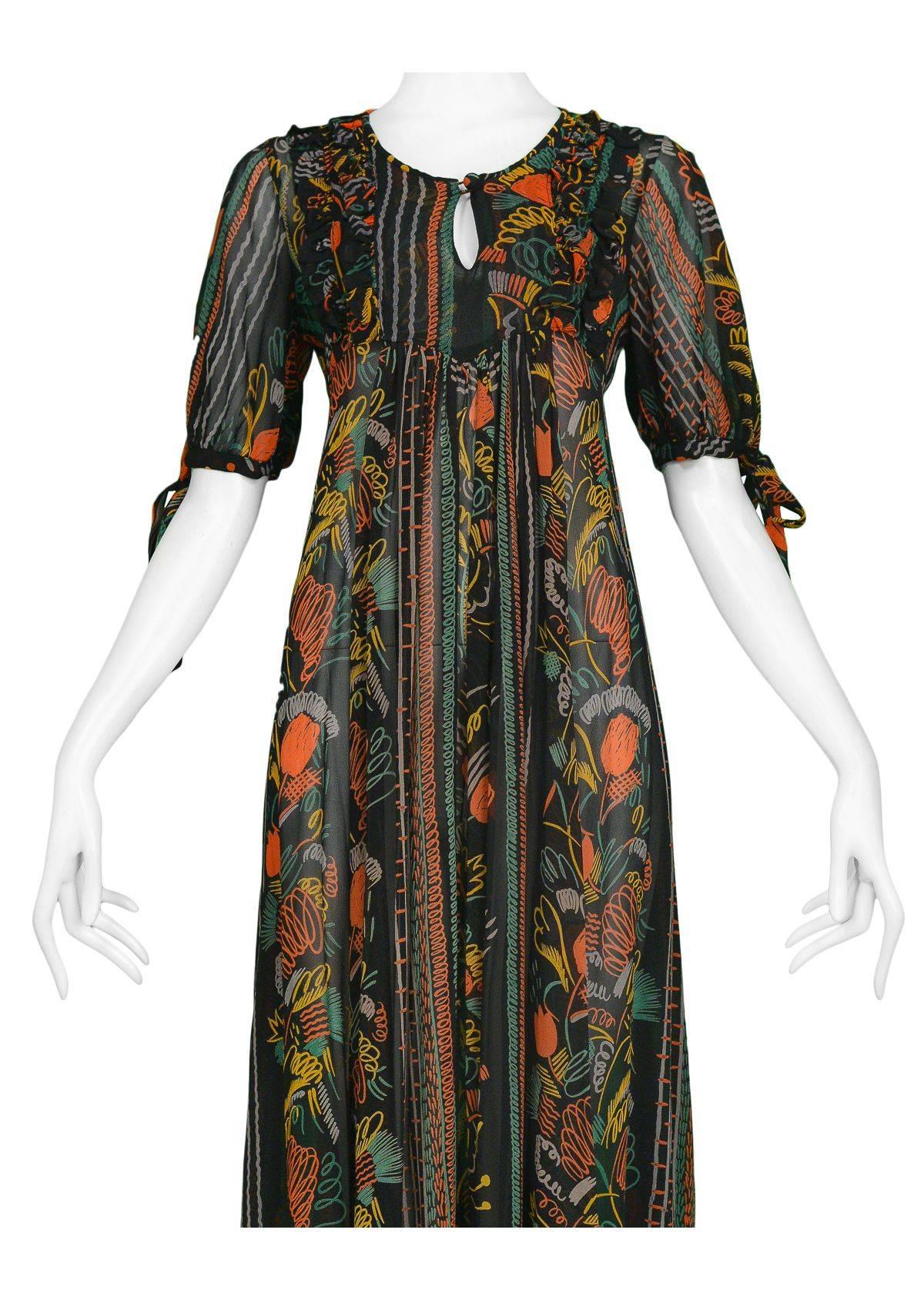 Vintage Ossie Clark black crepe maxi dress with colorful Celia Birtwell print. Dress features keyhole neck, ruffles at bodice, ties back and open sleeves with ties. Circa 1960's.