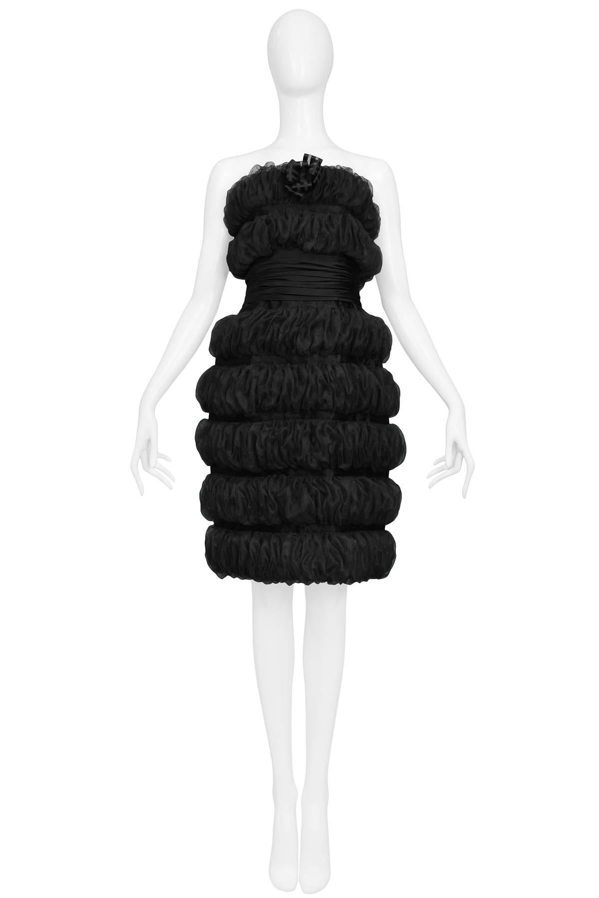 Vintage Karl Lagefeld black organza strapless tiered pouf cocktail dress with center bow at bodice. The dress was shown on the runway in the 1988 autumn/winter collection and was featured in editorials from the period. A truly stunning example from