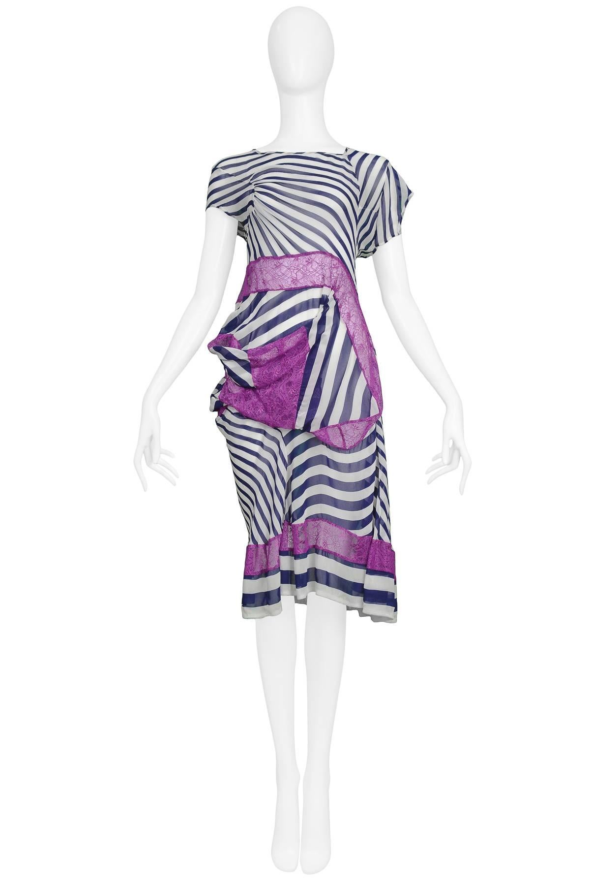 Vintage Junya Watanabe white and navy stripe knee length dress featuring abstract cap sleeves and purple lace draped throughout bodice and lining the hem. Runway piece from the Spring/Summer 2011 Collection.

Excellent Condition.

Size: SMALL