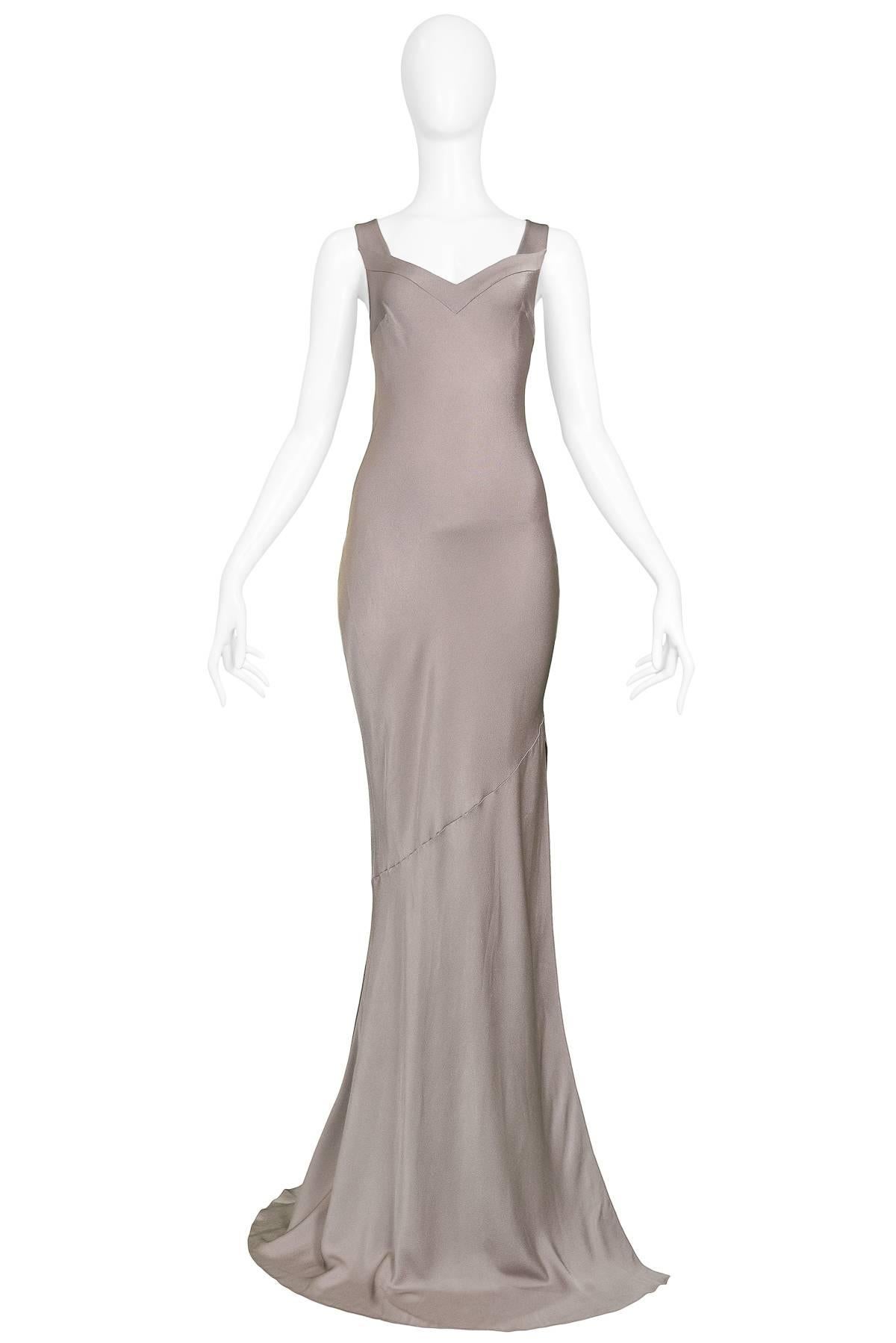 Vintage John Galliano metallic violet & silver tone bias cut evening gown. The gown features a dramatic side slit, circular seam and sweetheart neckline. Circa 1990s.

Excellent Condition. 

Size: 38

