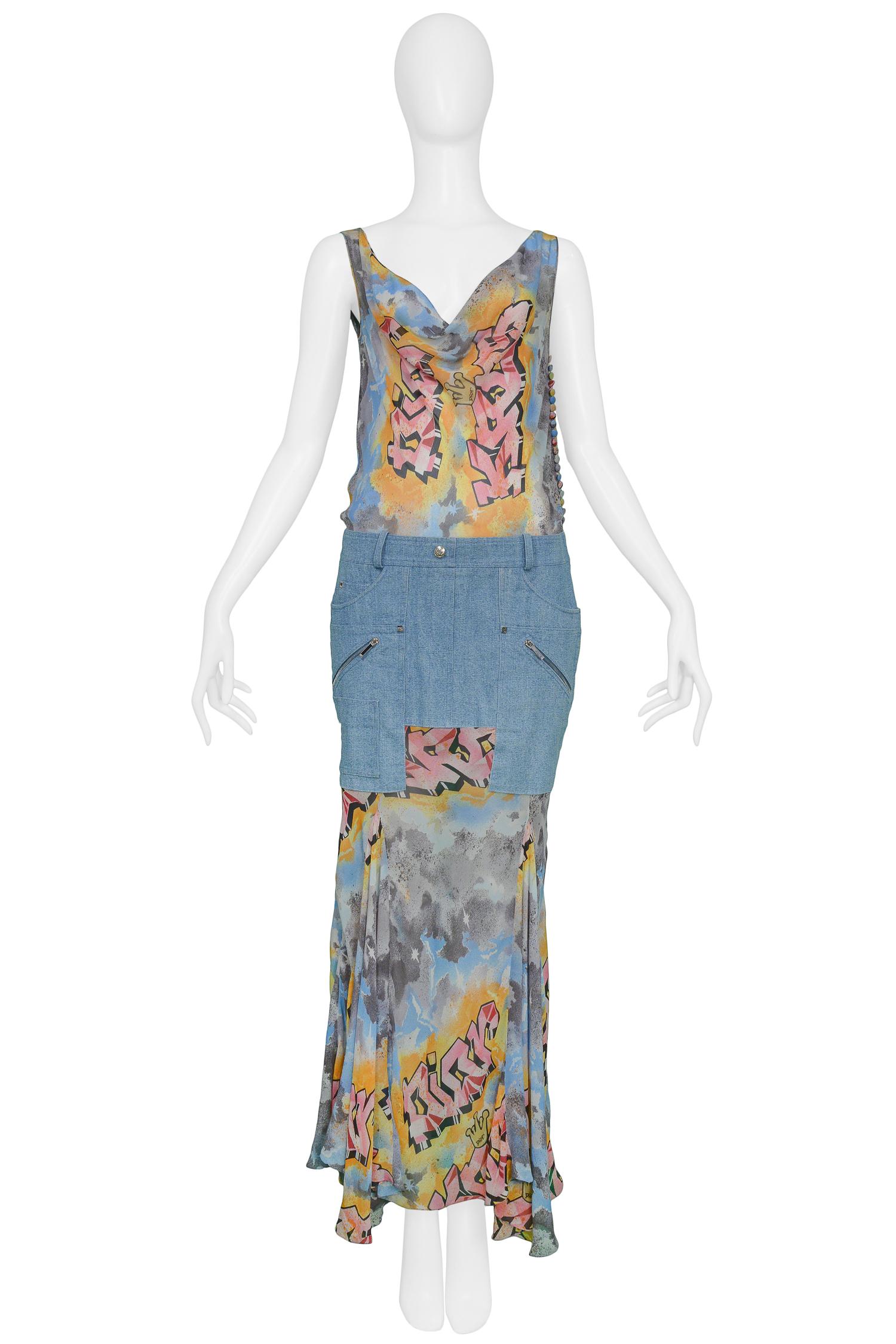 John Galliano for Christian Dior graffiti printed chiffon gown featuring denim skirt illusion, cowl neckline and draped back, silver-tone zip pockets & covered buttons at side. 

Excellent Condition. 

Size: 38