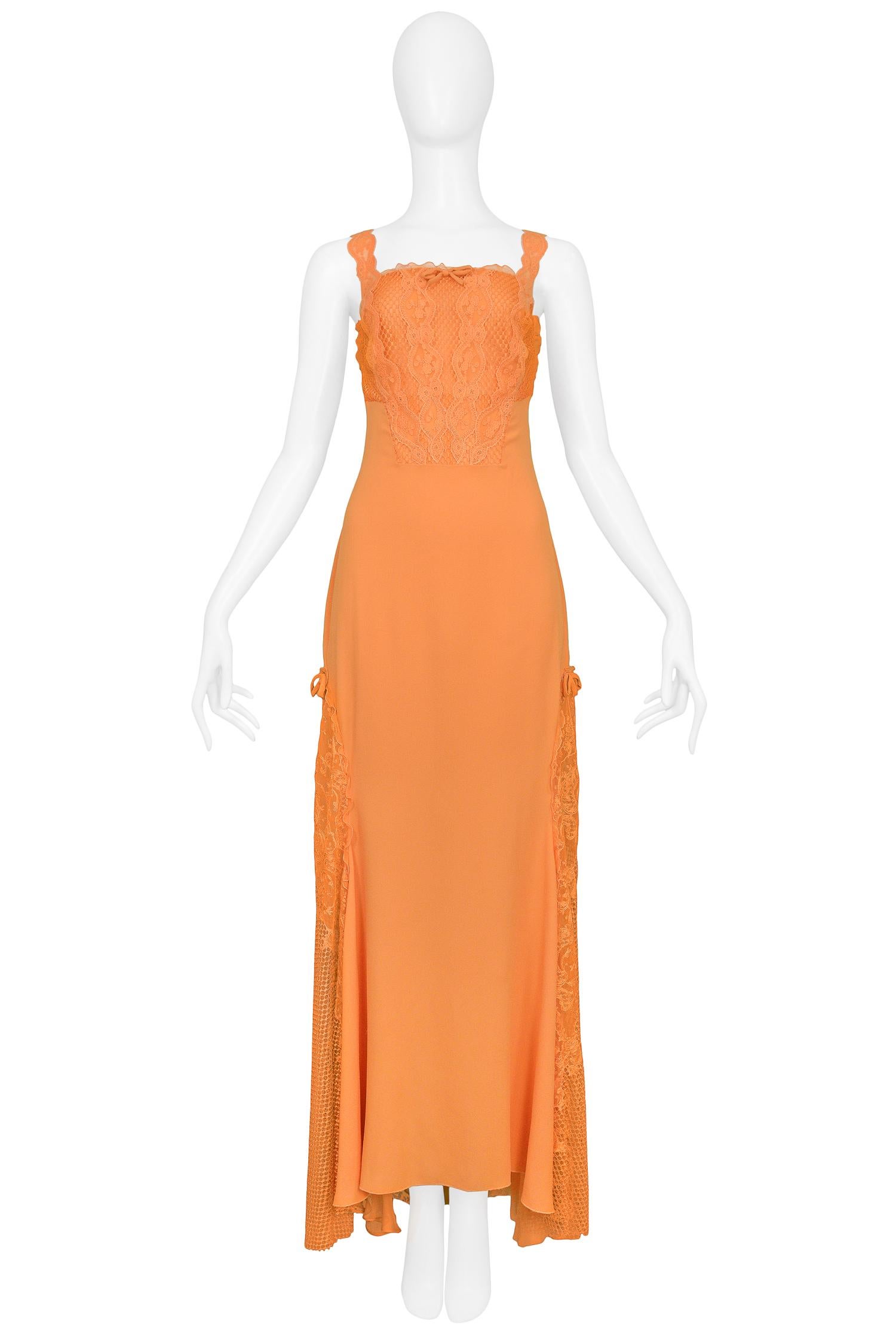 Vintage Gianni Versace apricot orange silk evening gown with lace & net inserts. The gown features bow detailing and rhinestone embellished emblems at straps. Runway piece from the Spring/Summer 1997 Collection.

Excellent Vintage Condition.

Size: