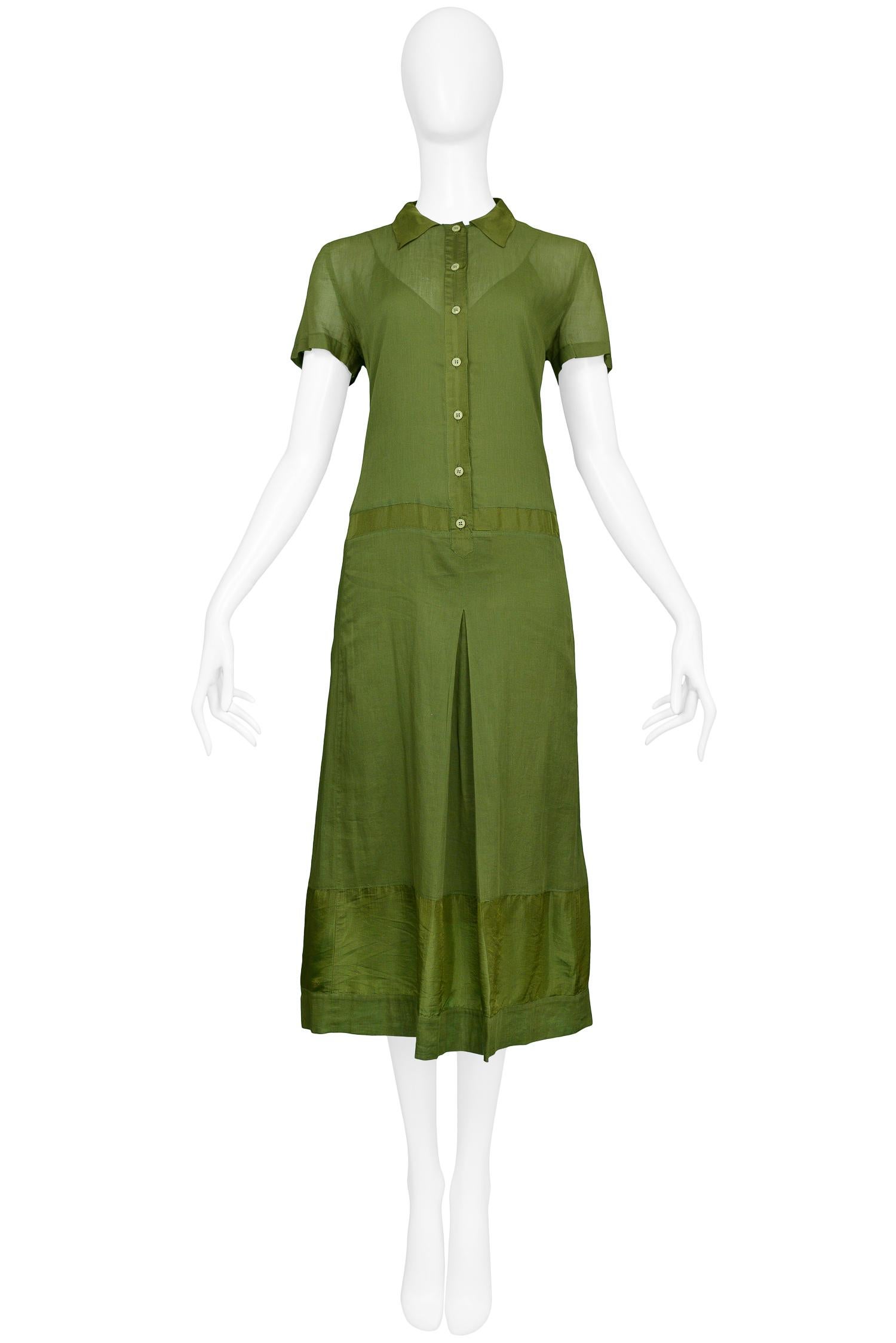 Vintage Miu Miu olive green cotton short sleeve button-front dress with silk accents at hem, waist, button panel & collar. The dress features a matching silk slip. From the 1999 Collection. 

Excellent Condition.

Size: 44