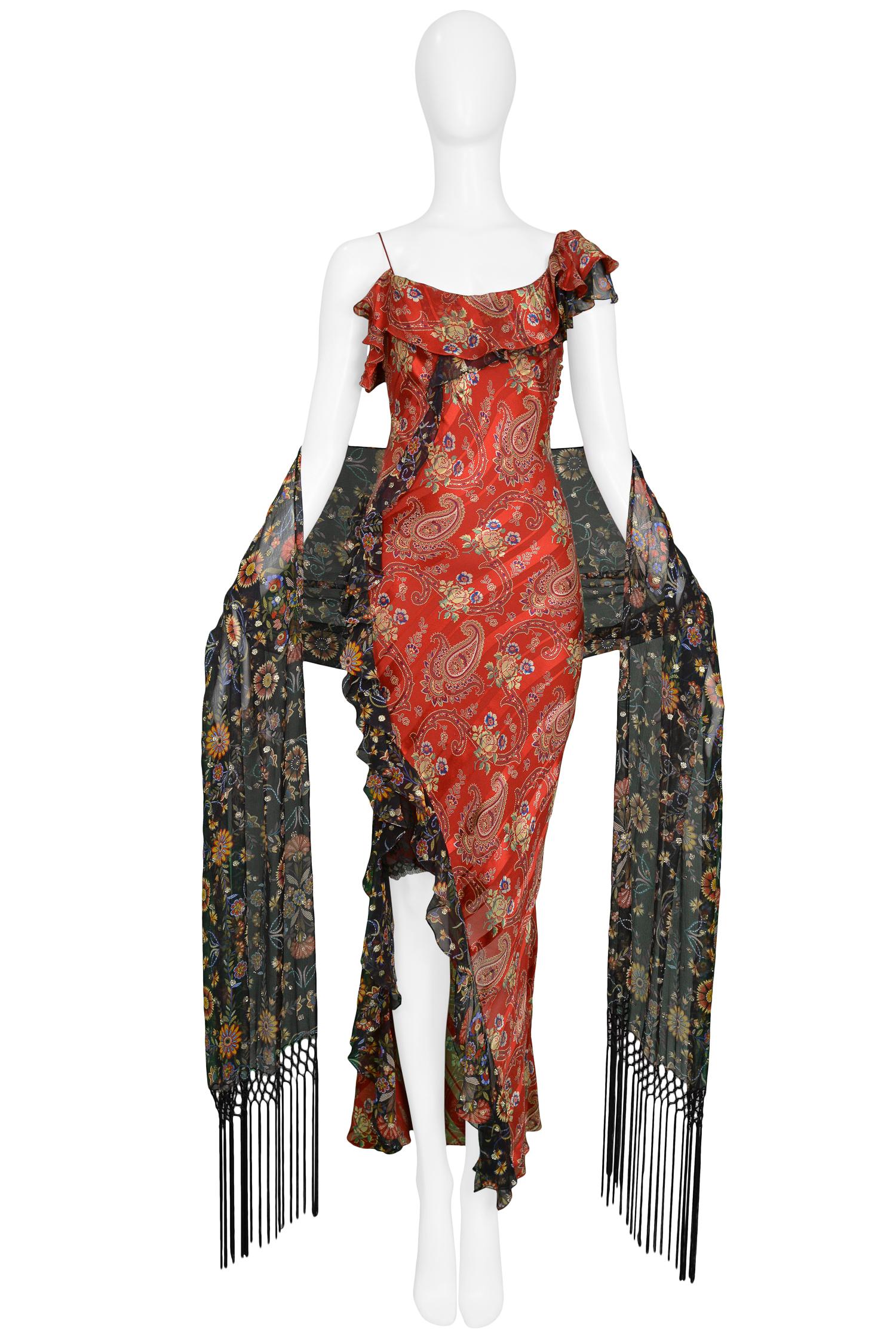 Vintage Dior by John Galliano asymmetrical red paisley silk bias cut dress with black printed chiffon trim and slit detail. The dress features a matching printed & fringe shawl.

Excellent Condition.

Size: 38