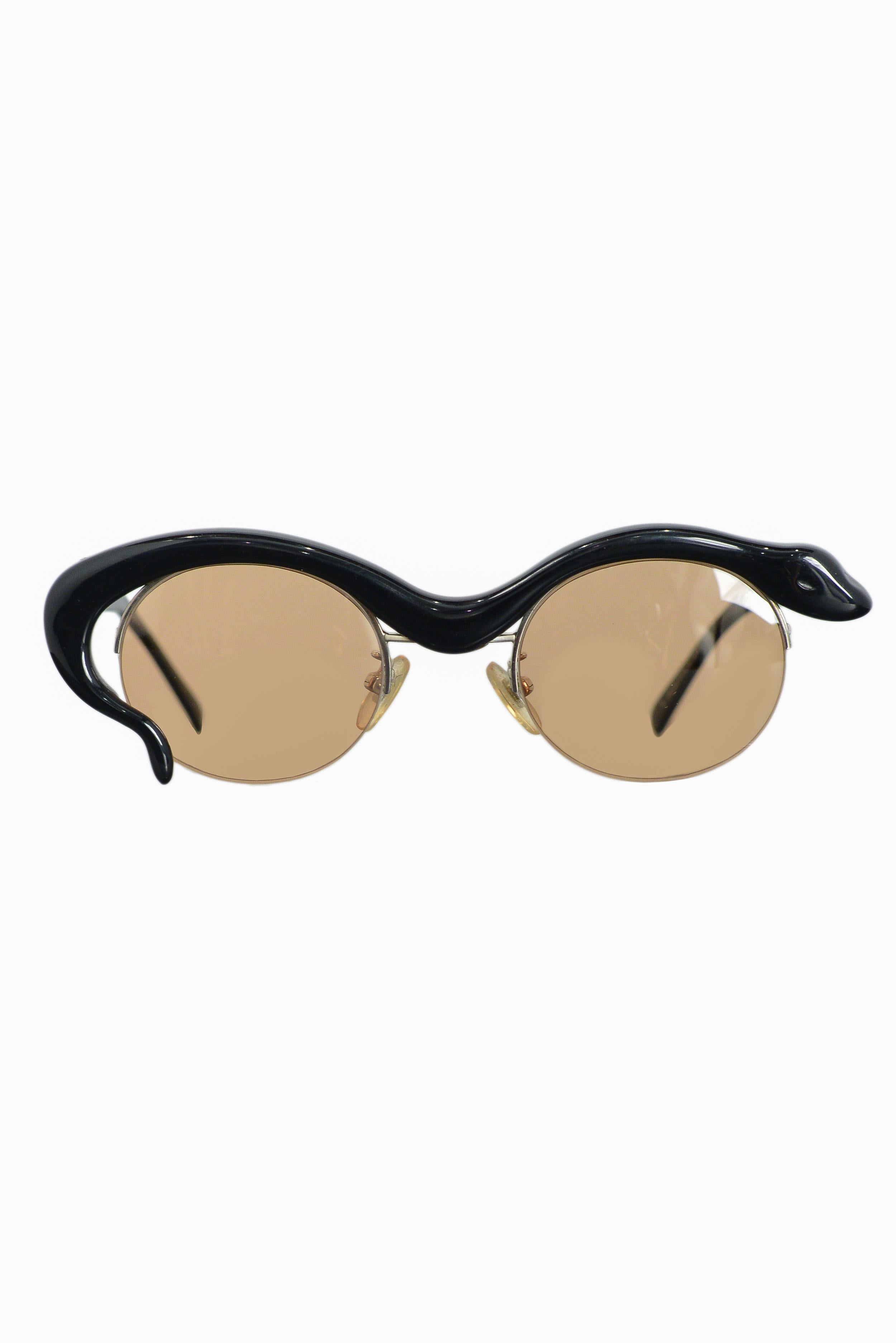 Vintage Yohji Yamamoto limited edition black snake shaped frames feautring amber colored lenses. Circa 1980's. Comes with original case.

Never Been Worn; Pristine Condition