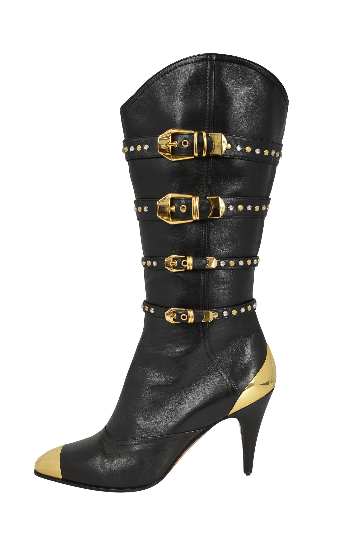 Vintage Gianni Versace black leather high heeled western boots with gold buckles, studs and cap toe & heel detail. From the Autumn/Winter 1992 Collection.

Never Worn; New. 

Size: 38.5
