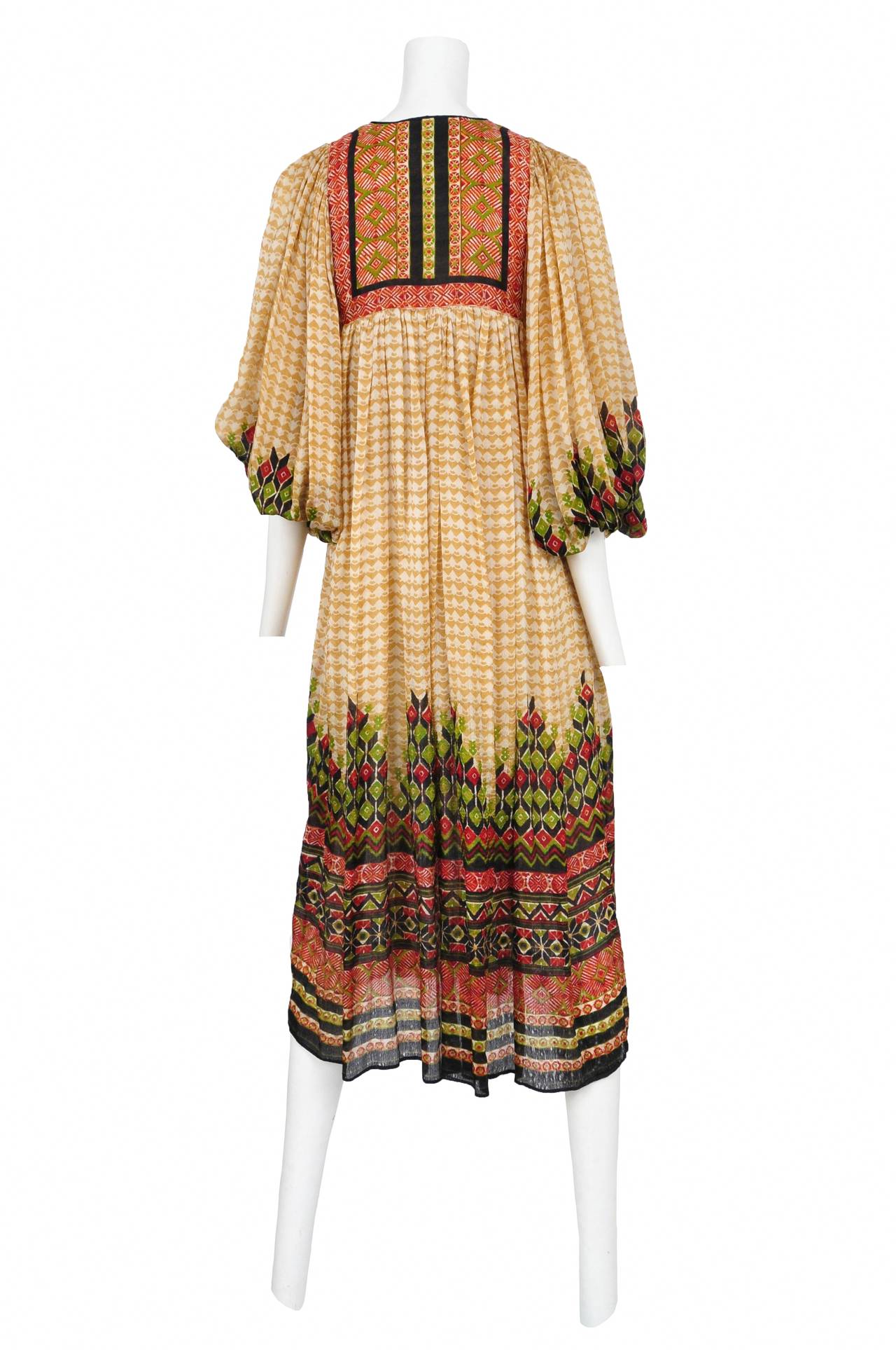 Vintage Judith Ann tan, green and rust silk bohemian print dress with traditional peasant sleeves, slit front printed square yoke and beaded ties at the collar that are capped off with faux horn pendants.