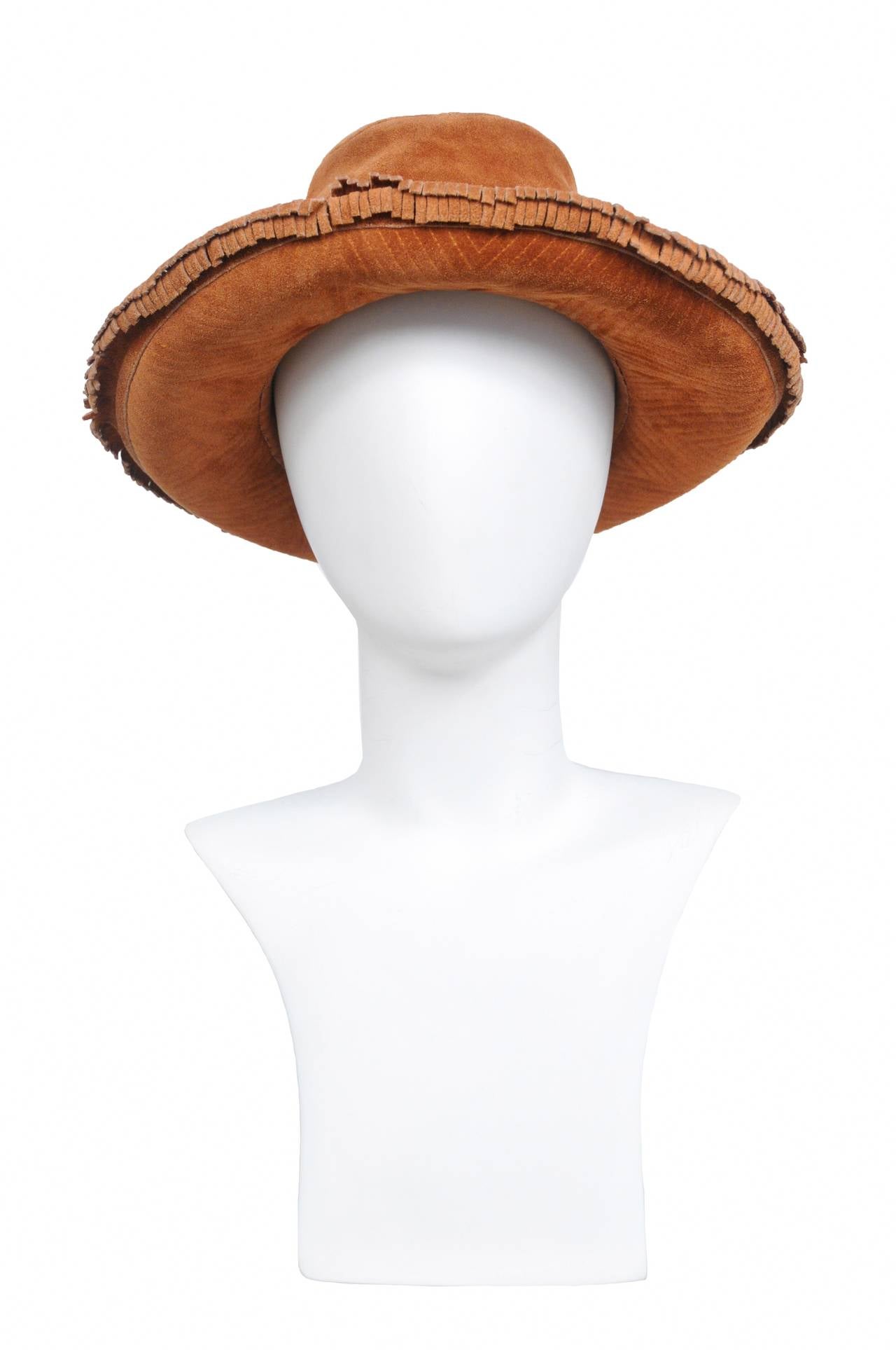 Vintage Yves Saint Laurent brown suede hat with raw fringe surrounding the brim and intricate stitch work on the underside of brim.