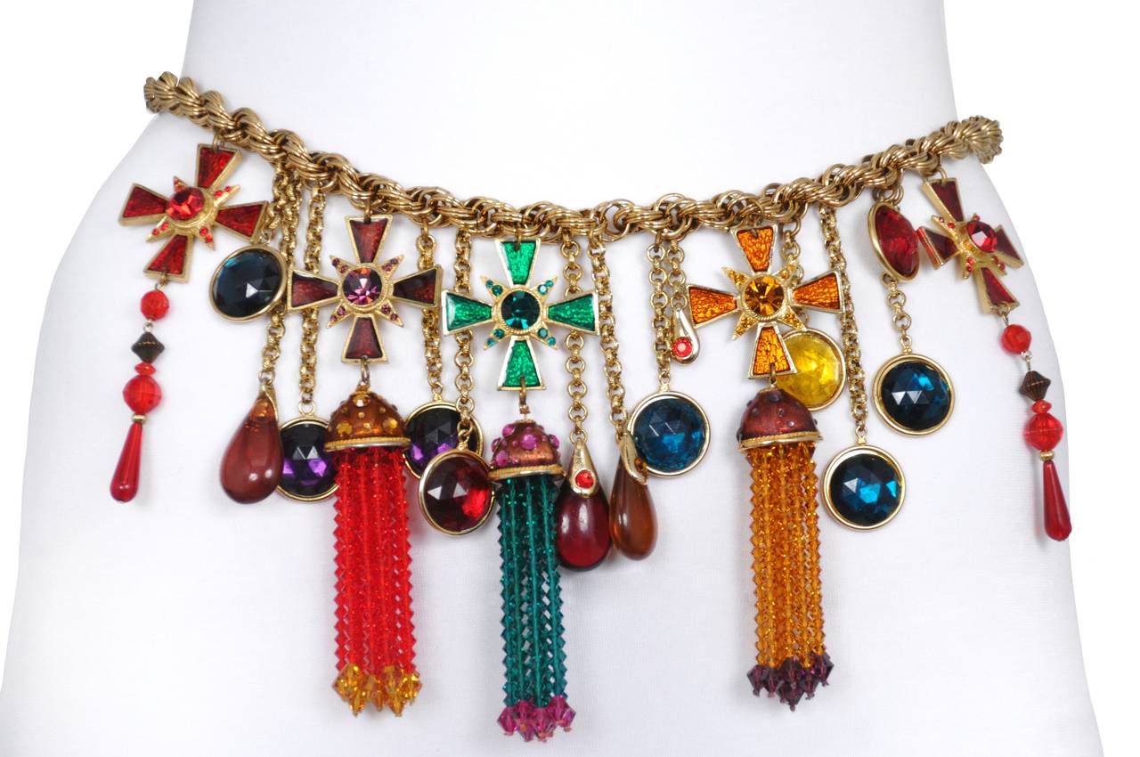 Vintage Yves Saint Laurent tassel belt with multicolor faceted rhinestones and crosses on a gold colored chain. The tassels are made of red, turquoise and yellow gold beaded fringe. Can also be worn as a necklace as pictured