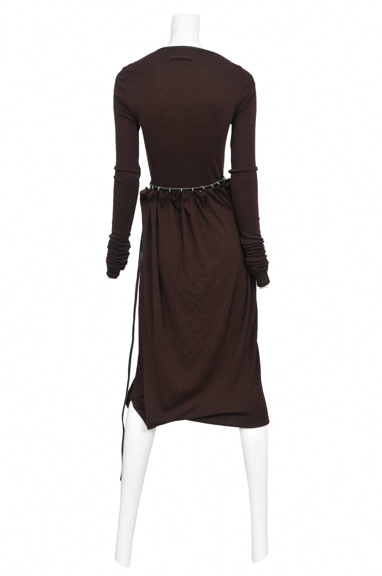 Vintage Jean Paul Gaultier plum brown jersey long sleeve dress with attached panel that folds up at knee and attaches at the waist with a black leather belt and silver rings.