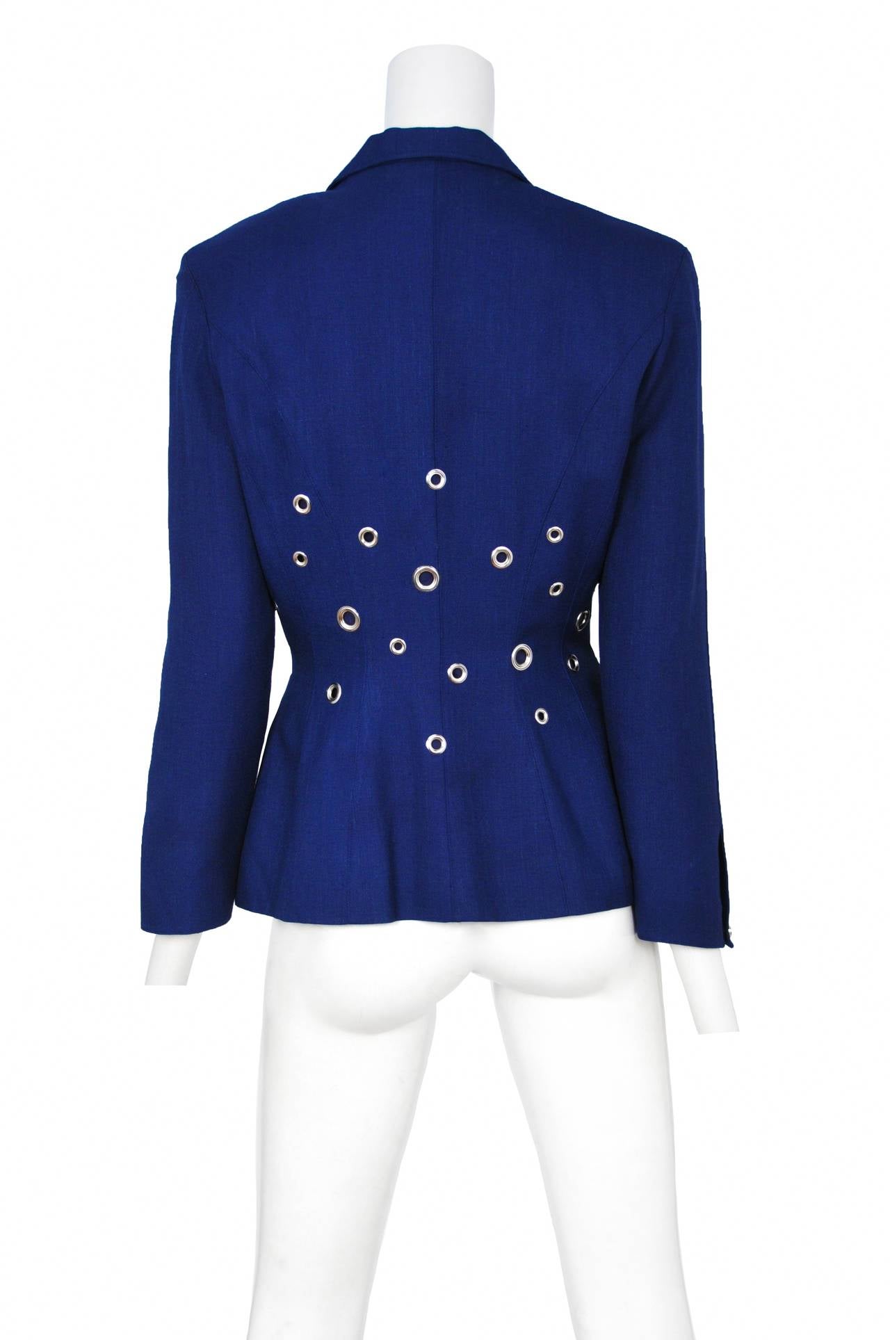 Vintage Thierry Mugler blue linen blazer with various size grommets decorating the waist of the jacket