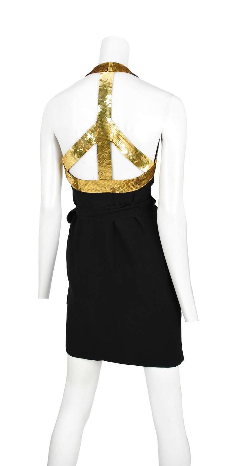 Black rayon twill wrap dress with bright gold sequin iconic Moschino peace symbol at back down in bright gold sequins.