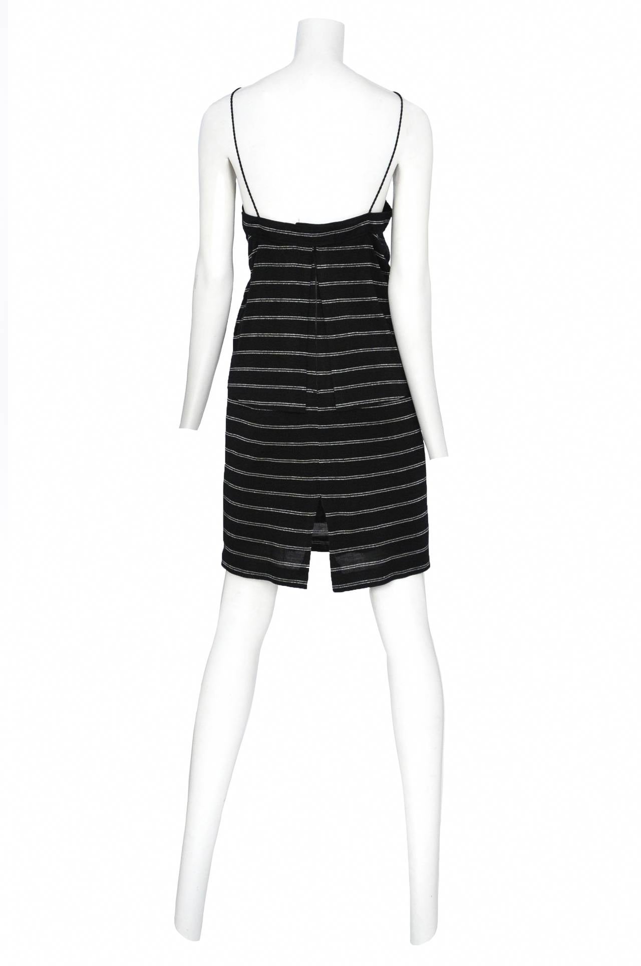 Vintage Jacques Cassia black and silver stripe knit dress featuring an architectural silver, black and silver glitter panel at the neckline held in place by black cording. Two pleated panels of the stripe fabric come out of the architectural collar
