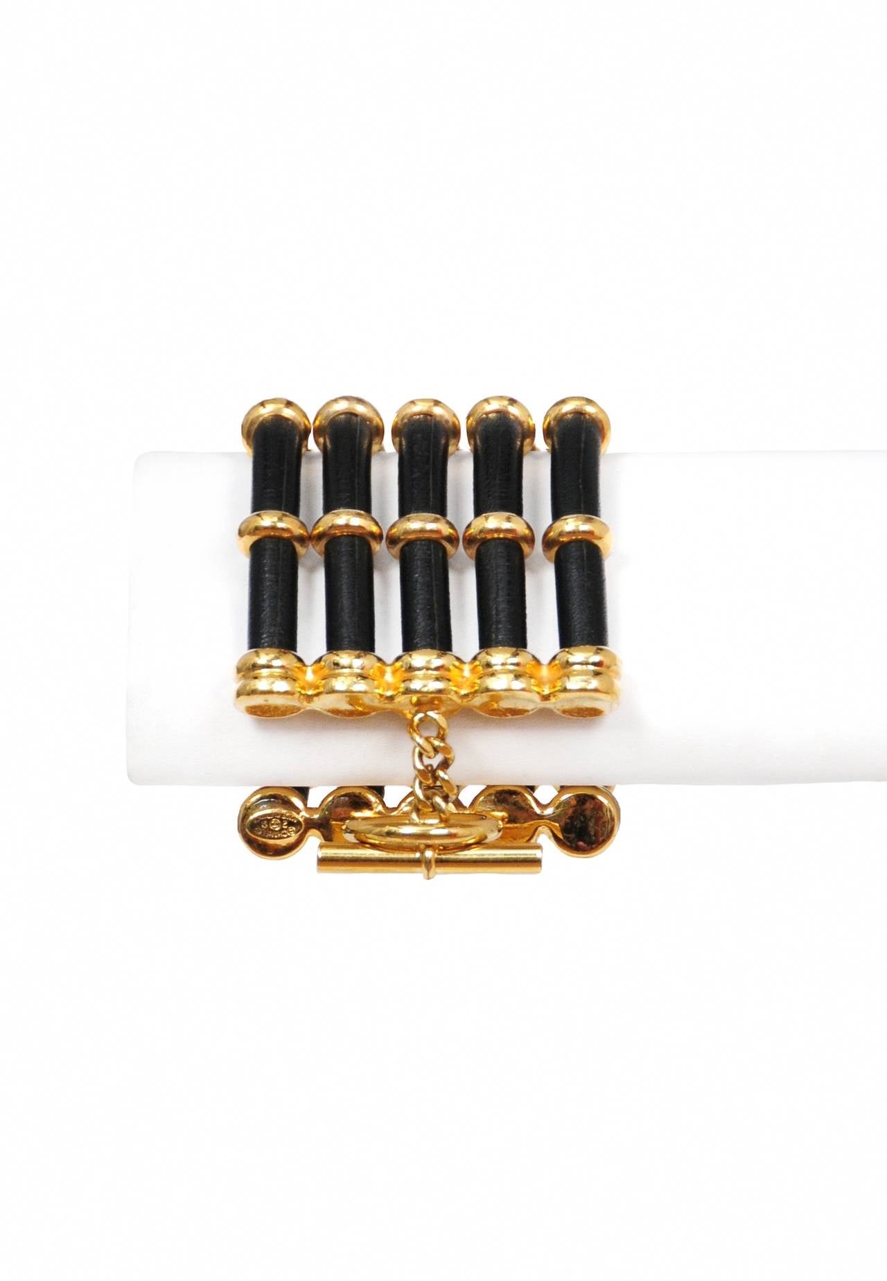 Vintage Chanel bracelet with 5 rows of black leather cording adorned with gold rondelles and finished off with a gold clasp