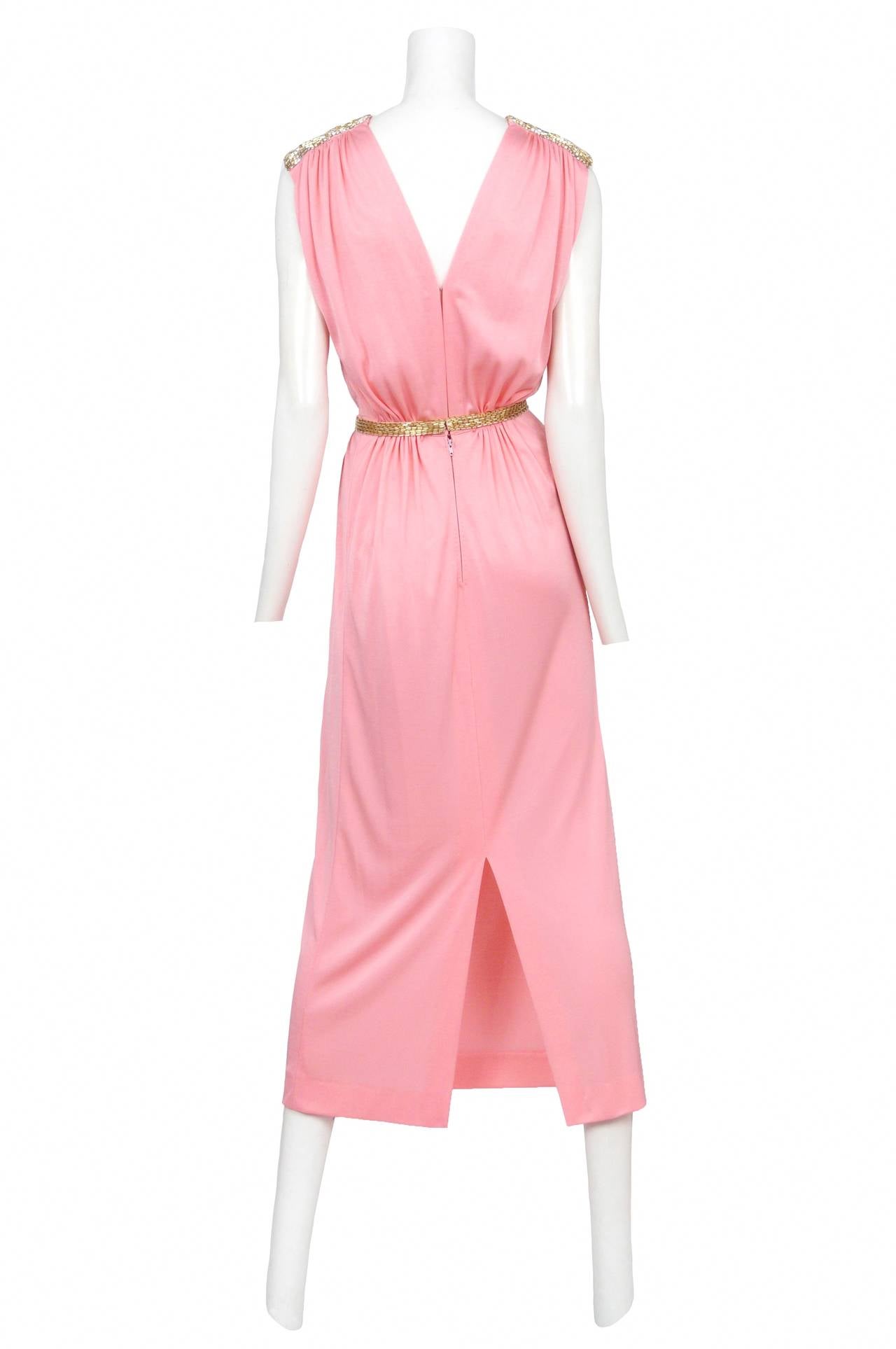 Vintage Loris Azzaro bright pink jersey maxi gown featuring a deep plunging neckline, gold and pink beading at shoulder caps and a matching gold beaded waist belt.