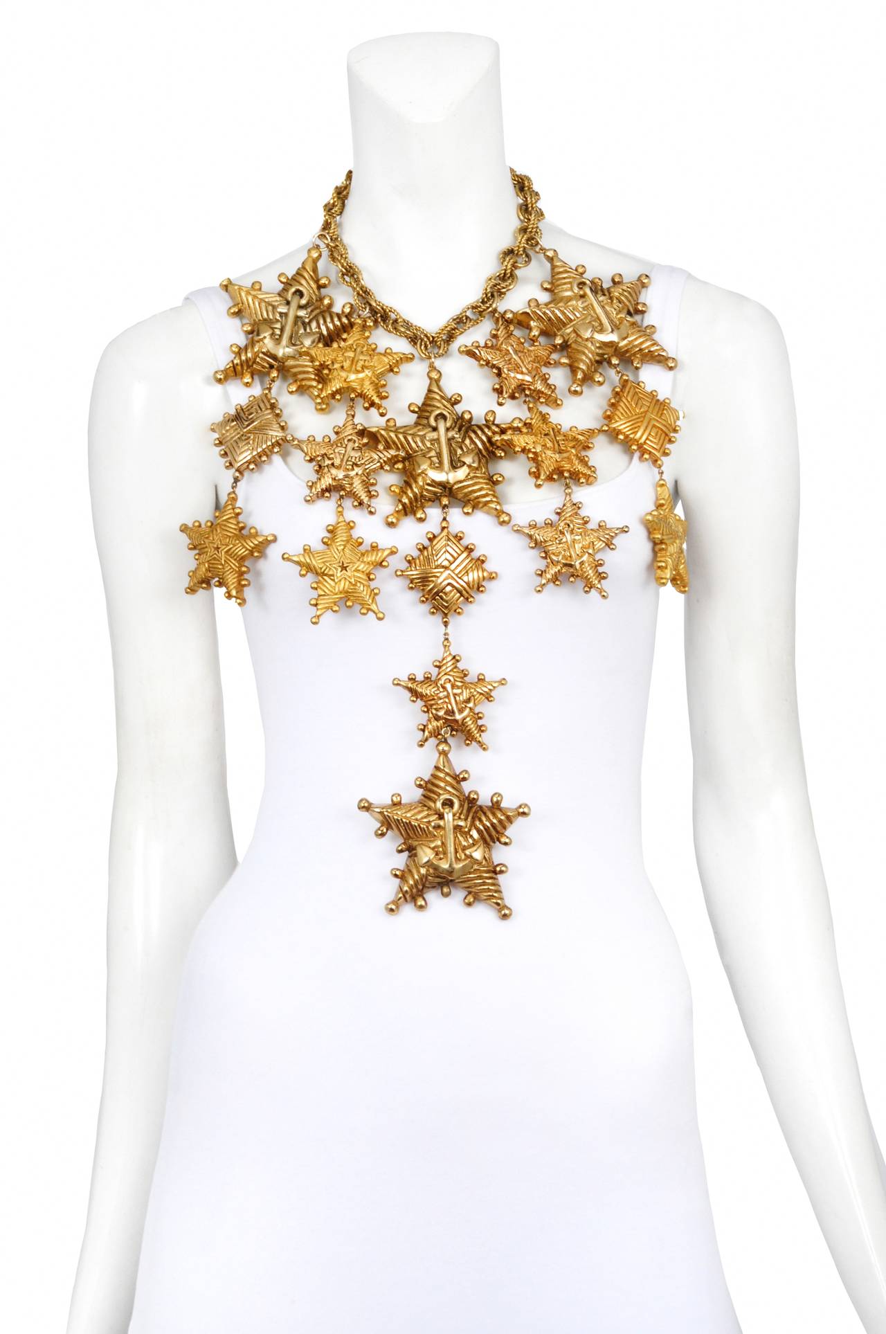Vintage Escada nautical inspired necklace featuring a series of oversize gold tone nautical stars adorned with anchors and rope detailing that attach to a rope style gold tone chain