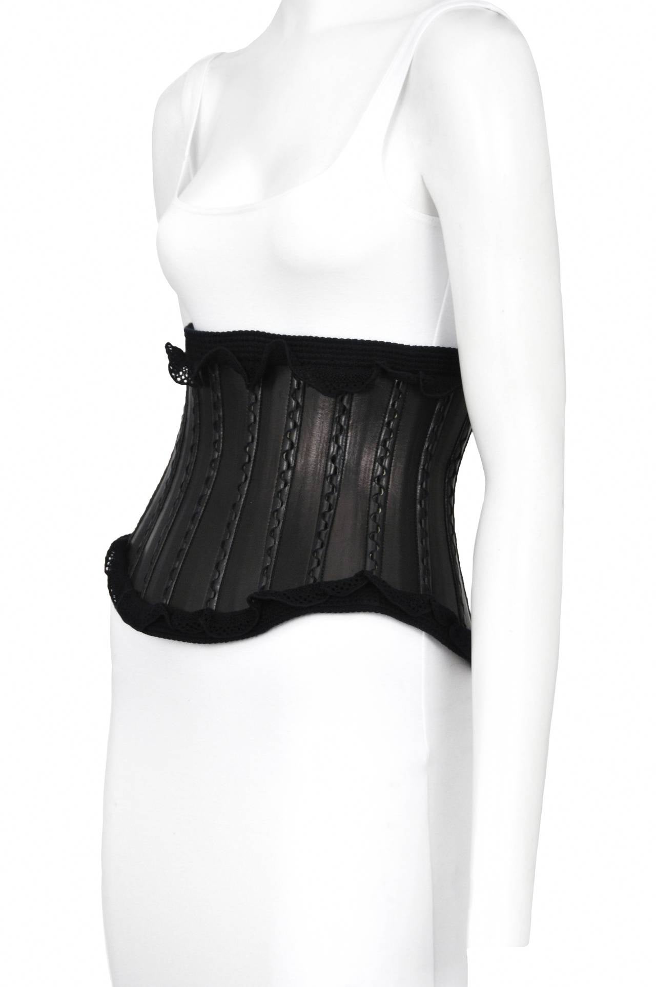 Vintage Azzedine Alaia black leather corset with ruffle detailing along the edges.